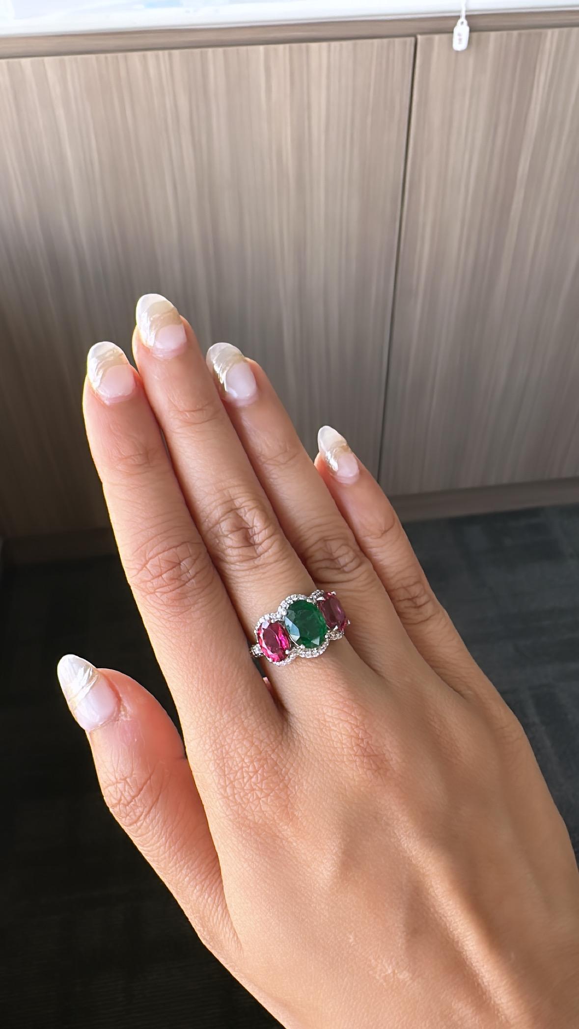 A very gorgeous and one of a kind, Emerald & Rubelite Band / Cocktail Ring set in 18K White Gold 
& Diamonds. The weight of the Emerald is 2.16 carats. The Emerald is completely natural, without any treatment and is of Zambian origin. The weight of