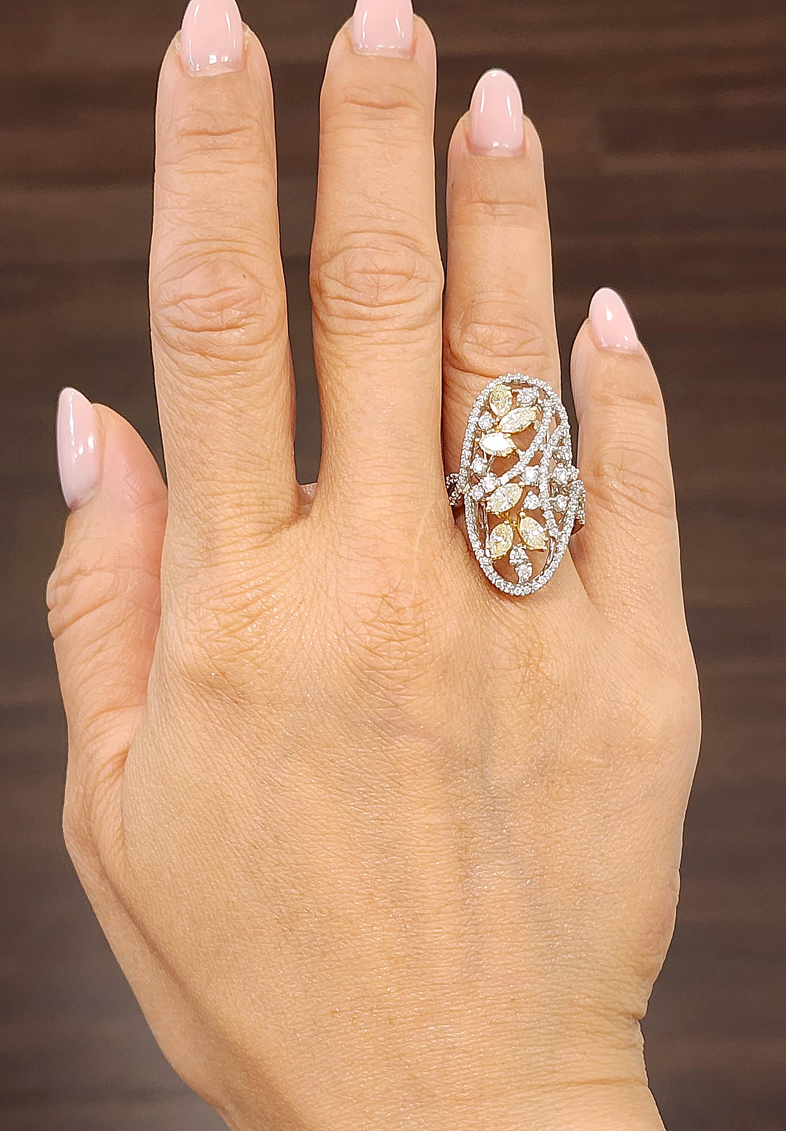 This stunning ring boasts beautiful natural yellow diamonds as the main stones, with a combined total of 131 diamonds. The 2.16 total carat weight and 18k white gold band make for a luxurious and timeless piece. The marquise shape of the main stones