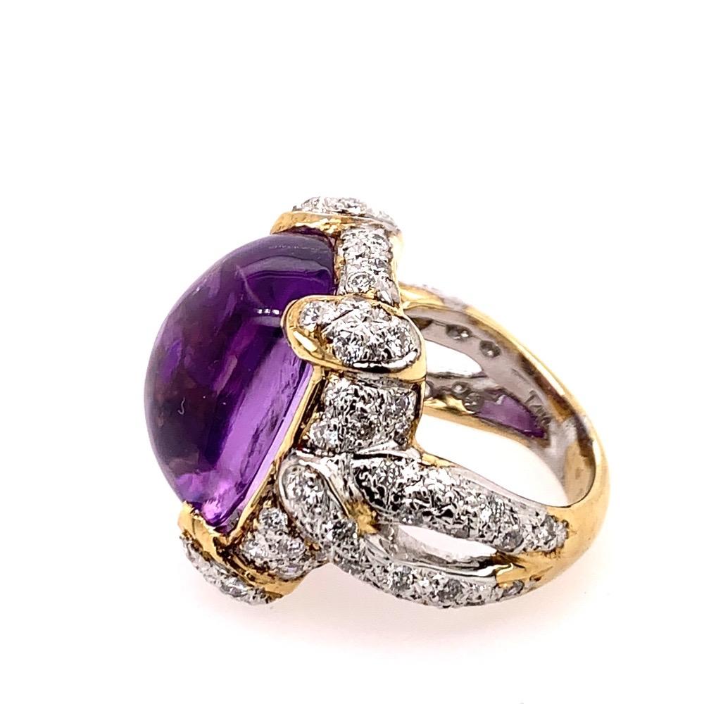 A stunning 21.68 carat (approx) 1960's retro 14k Gold Cocktail Ring (size 7). 

Set with an approximate 20 carat Natural Amethyst Cabochon measuring 18.8x15.5x10mm as well as 80 natural round brilliant diamonds weighing 1.68 carats, H in color and