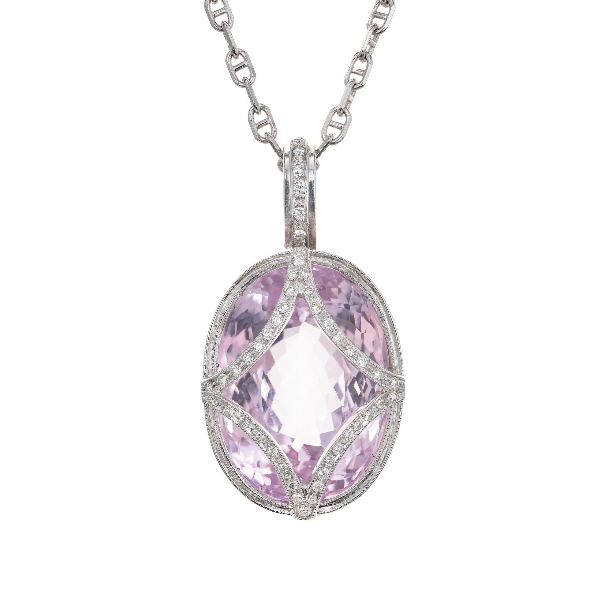 Bright pinkish purple kunzite and diamond pendant necklace. This unique pendant has a 21.69ct oval rich pink Kunzite set in a 14k white gold setting, accented with 57 round cut diamonds along the bail and front of stone. An 18 Inch 14k white gold