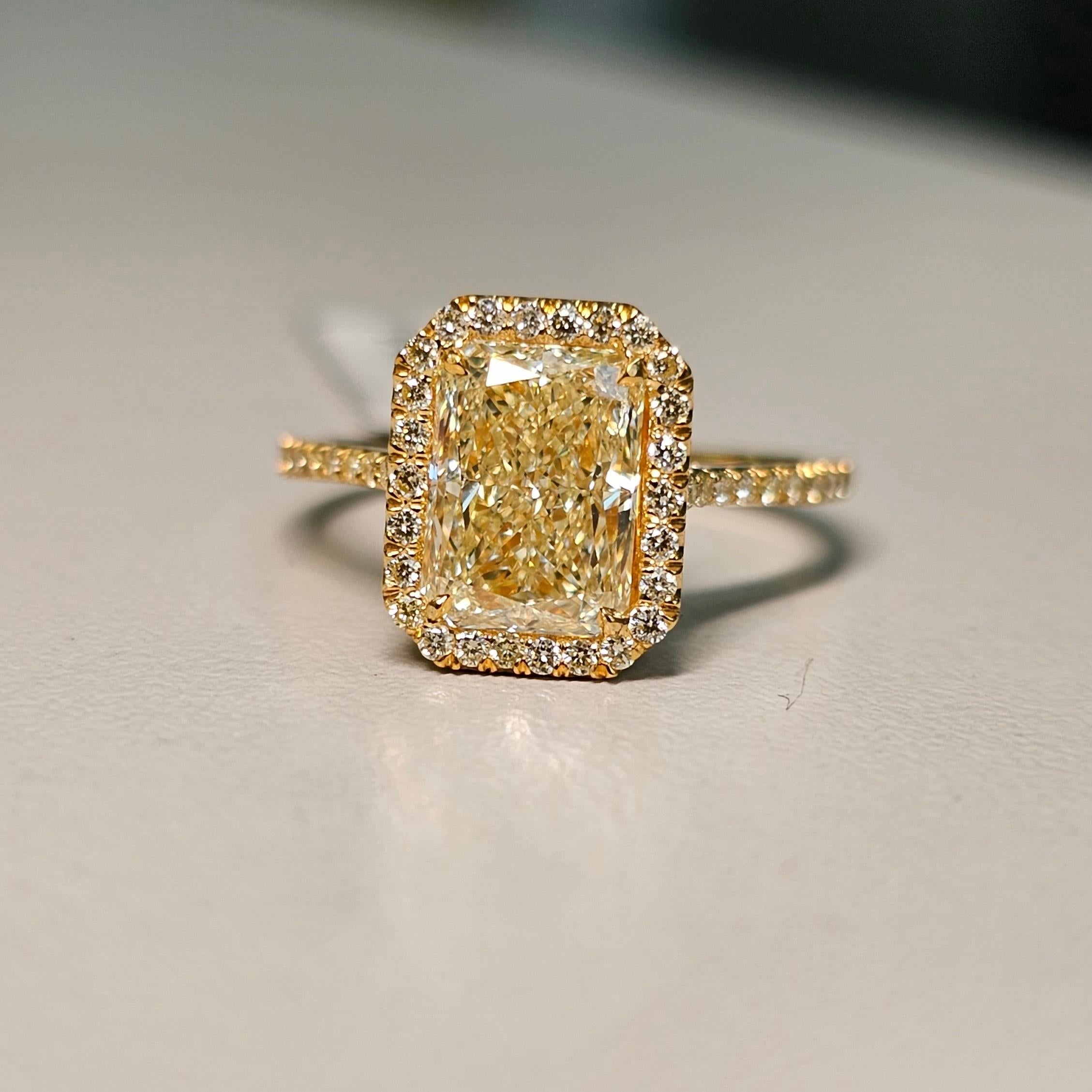 Our classic Yellow on Yellow style radiant diamond engagement ring. 
 
A perfectly elongated 2 carat WX colored radiant with a huge spread and amazing life. No bow tie, full of color.
Set in an all 18kt Yellow Gold ring with 0.32ct of yellow diamond