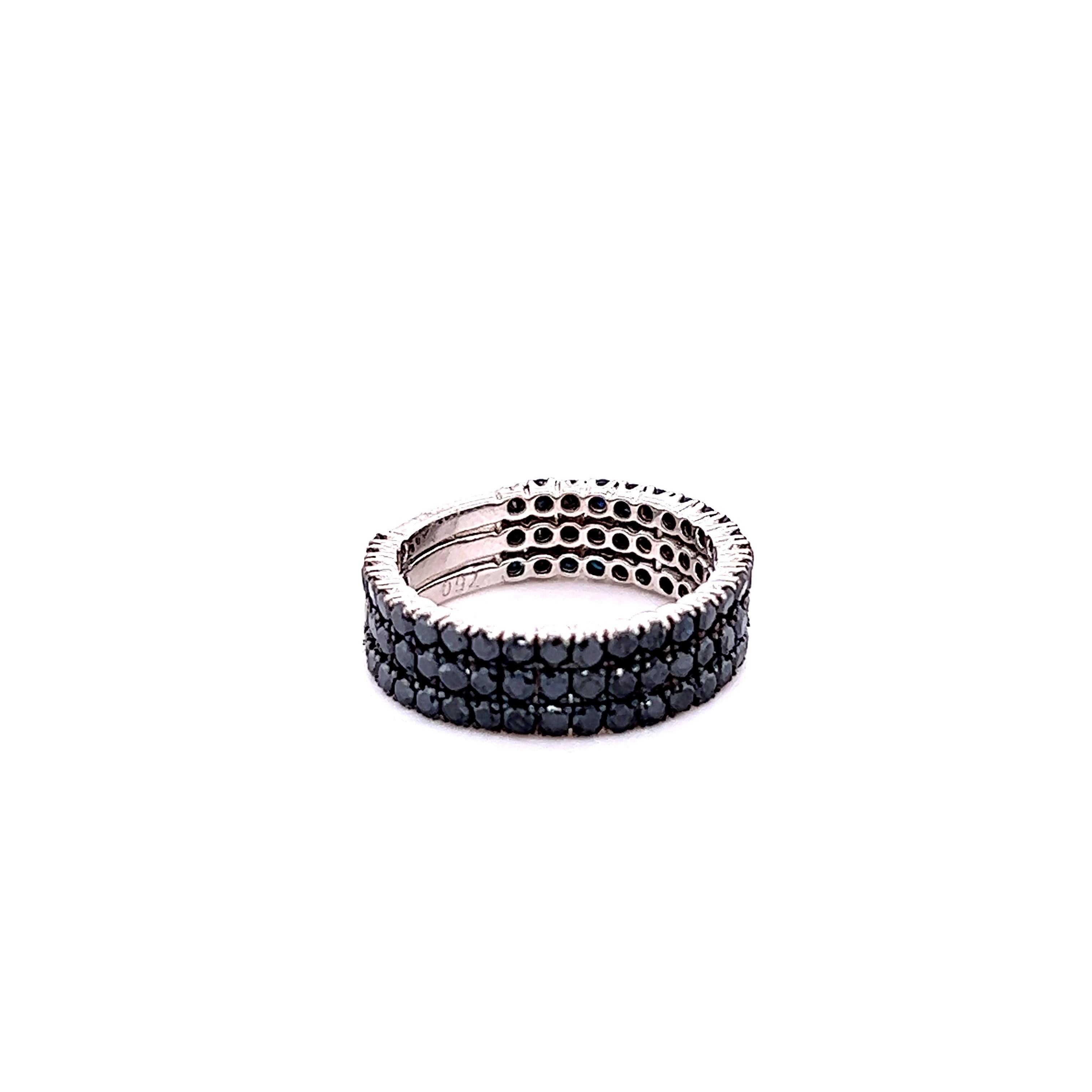 This ring has 90 Natural Round Cut Black Diamonds that weigh 2.17 carats. 
The black diamonds are natural and are color treated to attain its black color. 

It is set in 14 Karat White Gold and has a weight of approximately 4.4 grams. 
The width of