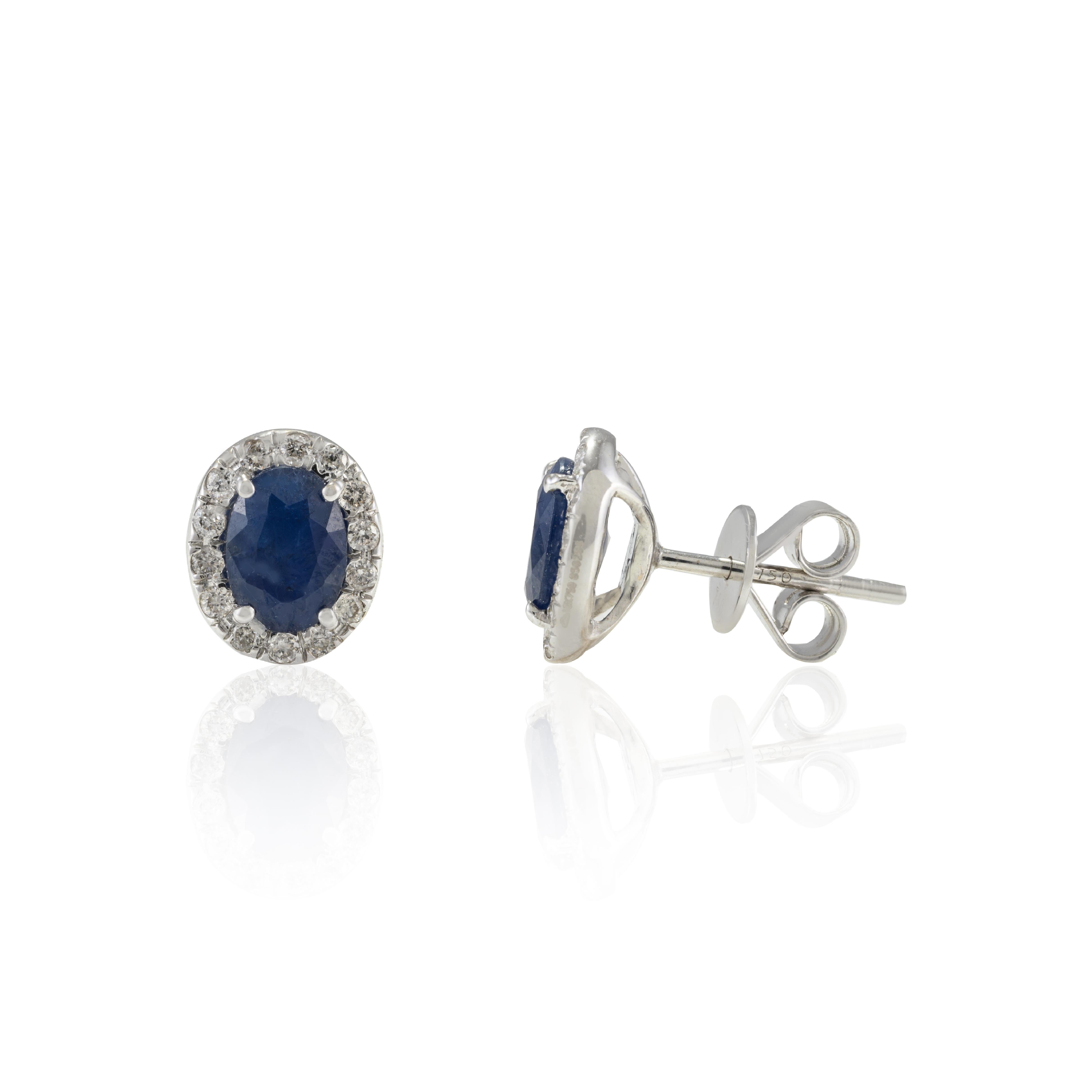 Deep Blue Sapphire and Halo Diamond Stud Earrings in 18K Gold to make a statement with your look. You shall need stud earrings to make a statement with your look. These earrings create a sparkling, luxurious look featuring oval cut