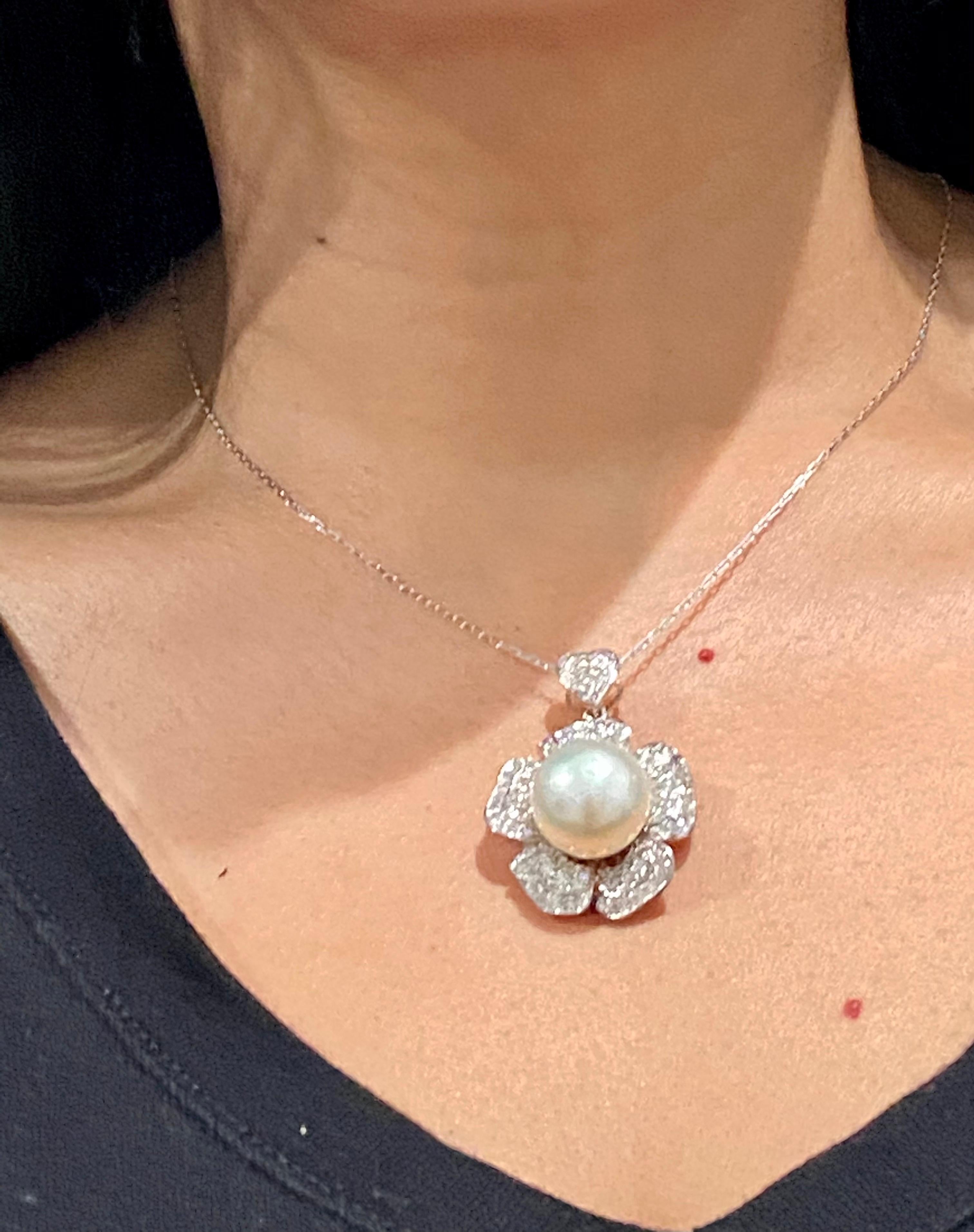 A stunning 2.17 Carat Diamond and South Sea Pearl 18 Karat White Gold Pendant

This one of a kind beauty has a magnificent 15mm South Sea Pearl in the center. It is surrounded by 104 Round Cut Diamonds that weigh 2.17 Carats that are set in a petal
