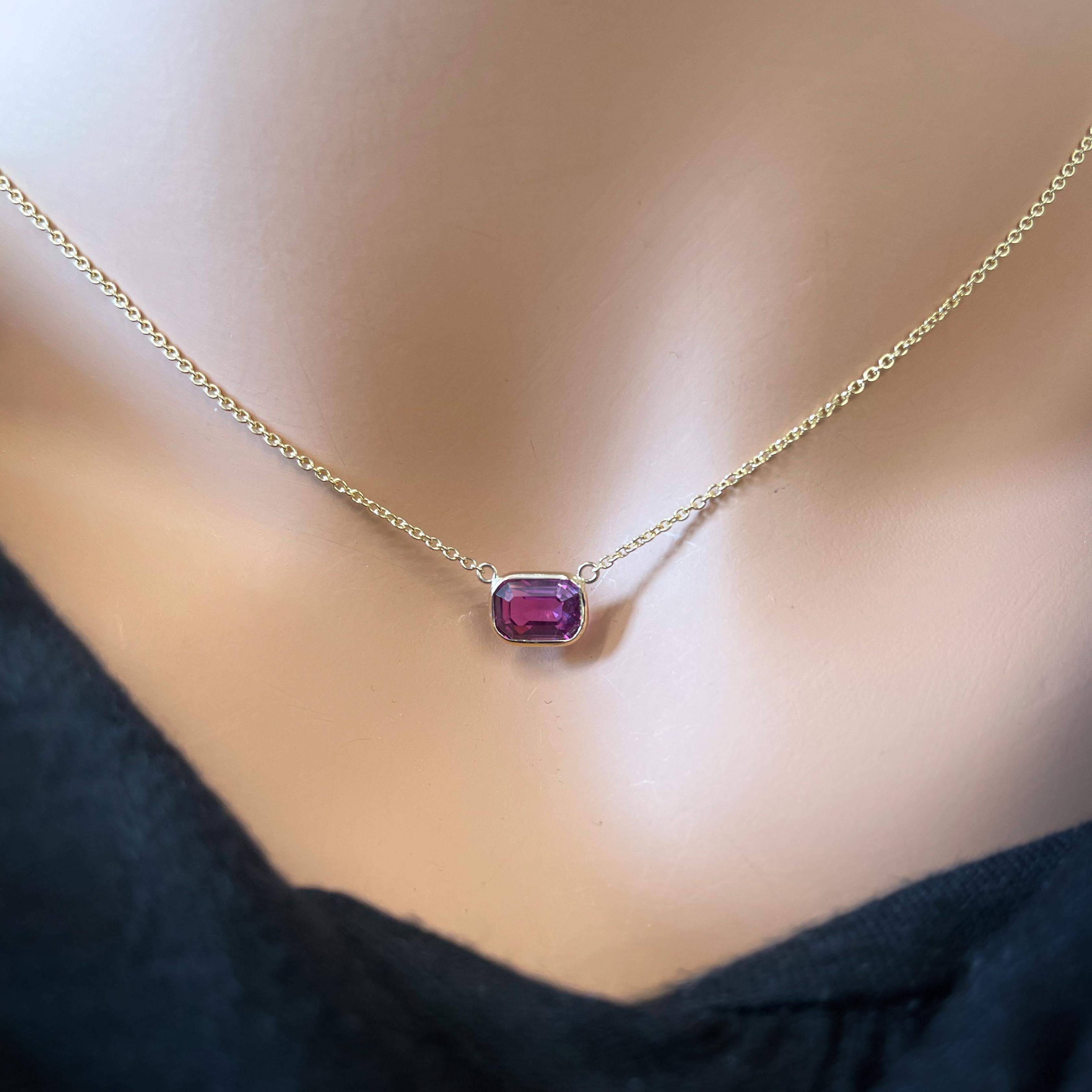 This necklace features an emerald-cut pinkish red sapphire with a weight of 2.17 carats, set in 14k yellow gold (YG). Pinkish red sapphires are highly prized for their unique and rich color, and the emerald cut can enhance the gemstone's natural