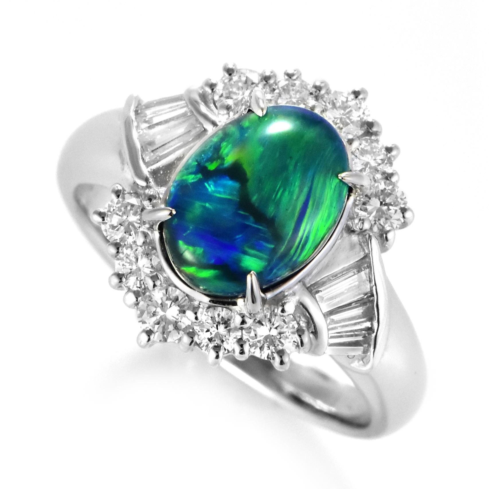 A beautiful ring featuring a 2.17 Carat Australian Black Opal and 0.61 Carat Diamonds made in Platinum. The Opal displays very good play of color! Opals are known for exhibiting flashes of rainbow colors known as 