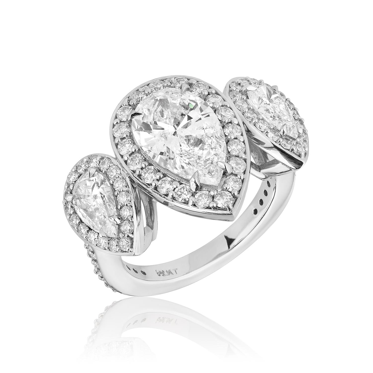 Three Stone Pear Shaped Ring.
Centered upon a 2.17 Carat Stone Flanked By 2 Pear Shapes weighing 1.02 Carats.
Diamond Pave weighing 1.30 Carats.
All stones are of EF Color.
Set in Platinum.