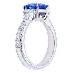 2.17 Carat Radiant Cut Blue Sapphire Ring with Trapezoids and Diamond Band
