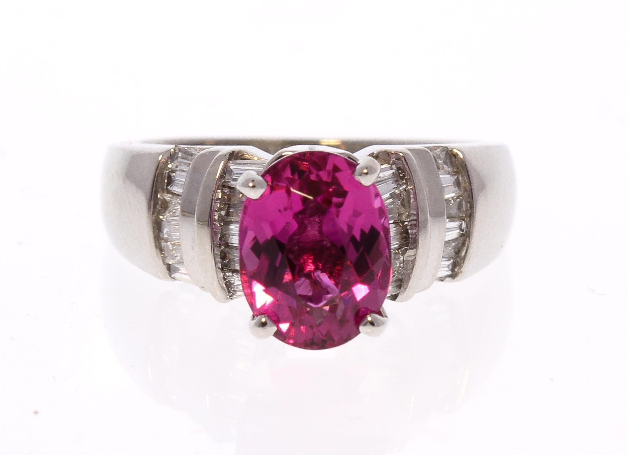 Incredible color and sparkle along with show-stopping style make this glamorous diamond and rubellite ring stand out. Designed in brightly polished 14 karat white gold, this ring features an oval cut intense raspberry pinkish-red fine quality 2.17