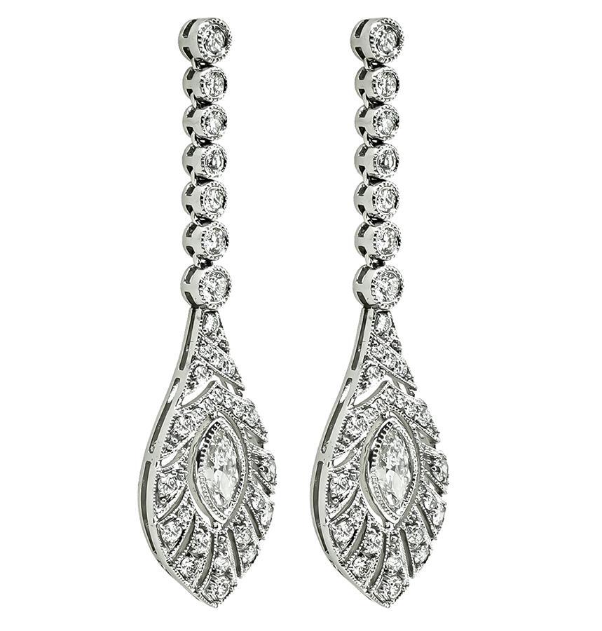 This is a charming pair of platinum dangling earrings. The earrings feature sparkling marquise and round cut diamonds that weigh approximately 2.17ct. The color of these diamonds is G with VS clarity. The earrings measure 45mm by 13mm and weigh 10