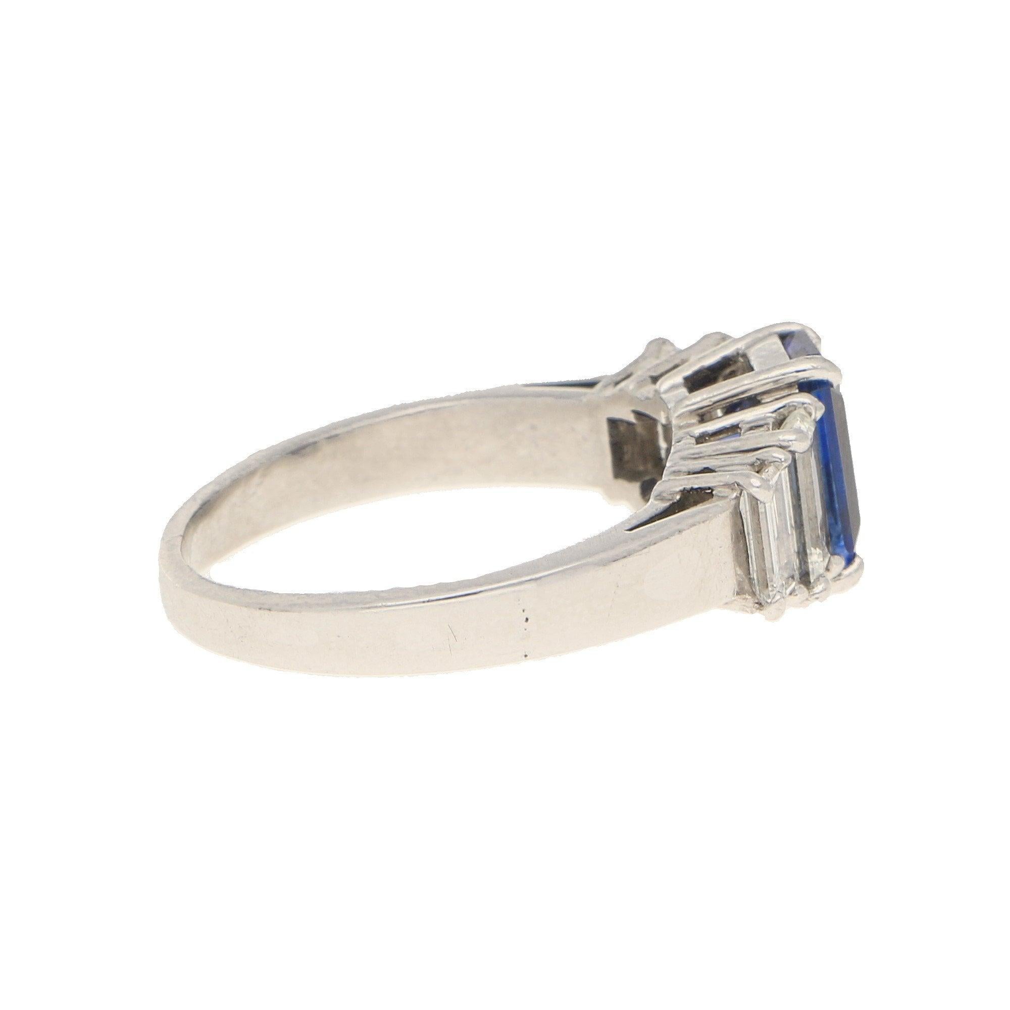 An elegant sapphire and diamond five stone ring set in platinum. 

This beautiful piece centrally features an emerald cut sapphire of vibrant royal blue colouring. This sapphire is securely four claw set to centre and is flanked to each side by two