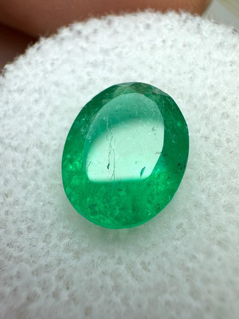 Stone: Emerald
Weight: 2.18-carats
Shape: Oval Cut
Clarity: Transparent
Luster: Very Good
Color: Rich Medium Green
Measurements: 10.40m x 8.12mm x 4.77mm
Geographic Origin: Colombia
Treatment: Natural, Oiling

Comments: Due to their growth