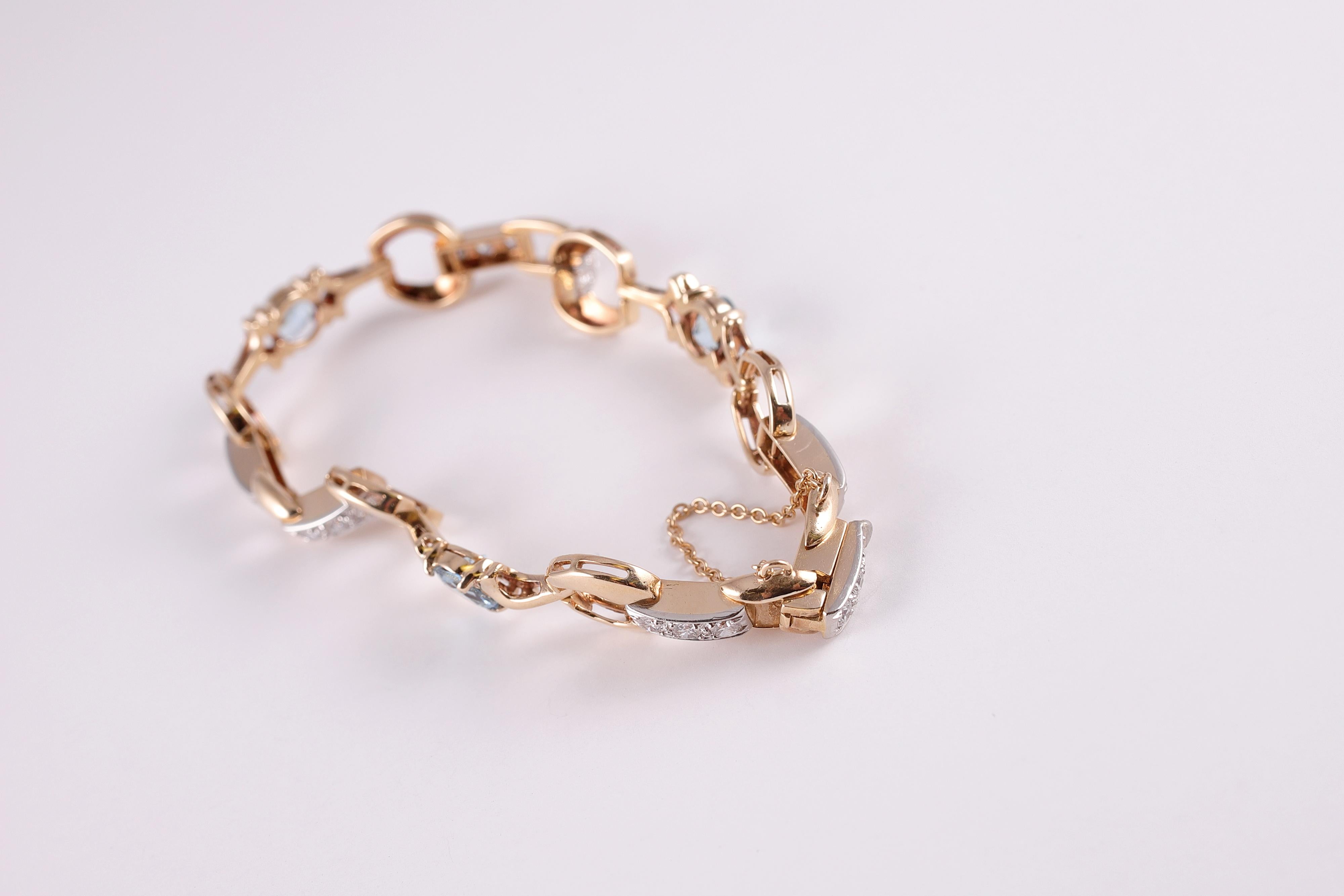 Dazzling bracelet with 2.18 carats of lovely aquamarines and 1.05 carats of channel set diamonds -- all in 14 Karat yellow gold and palladium.  Light and lovely!!