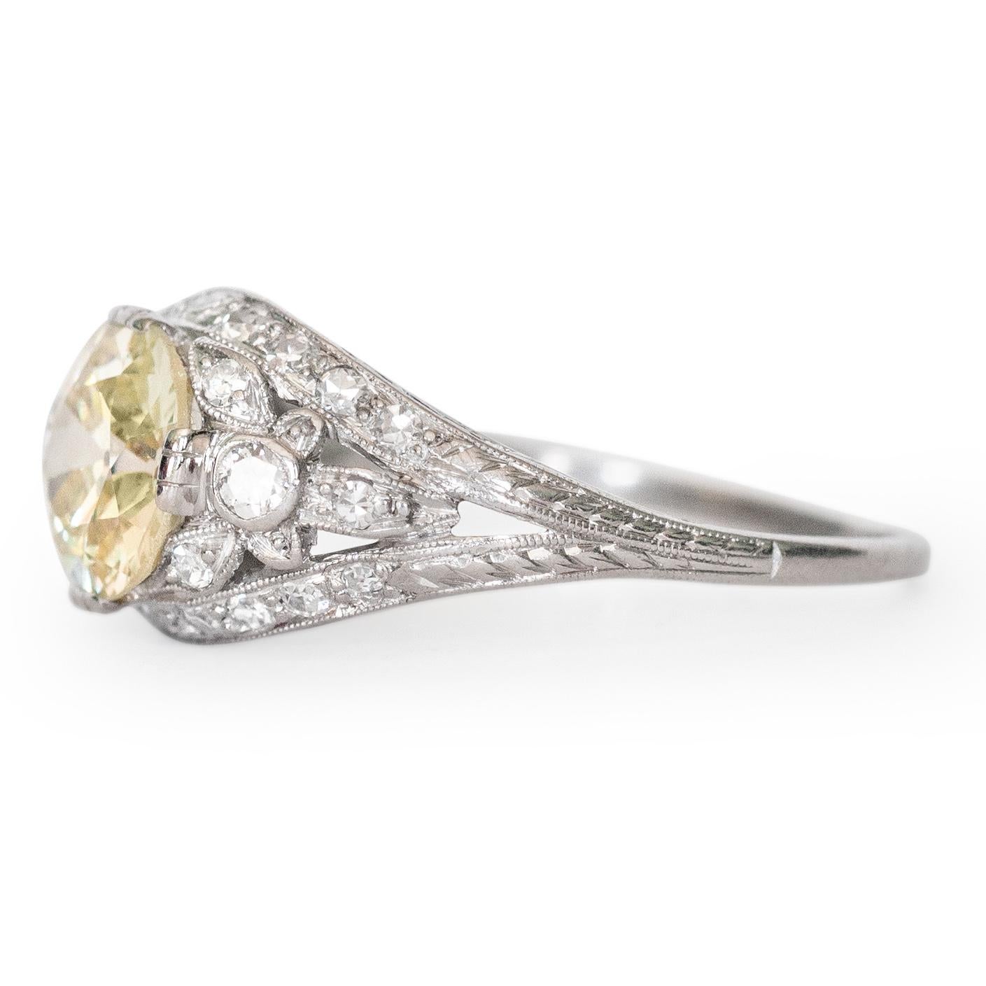 Ring Size: 9
Metal Type: Platinum [Hallmarked, and Tested]
Weight: 4 grams

Center Diamond Details:
Weight: 2.18 carat
Cut: Old European Brilliant
Color: Light Yellow (Q/R)
Clarity: SI1

Side Diamond Details:
Weight: .30 carat, total weight
Cut: Old