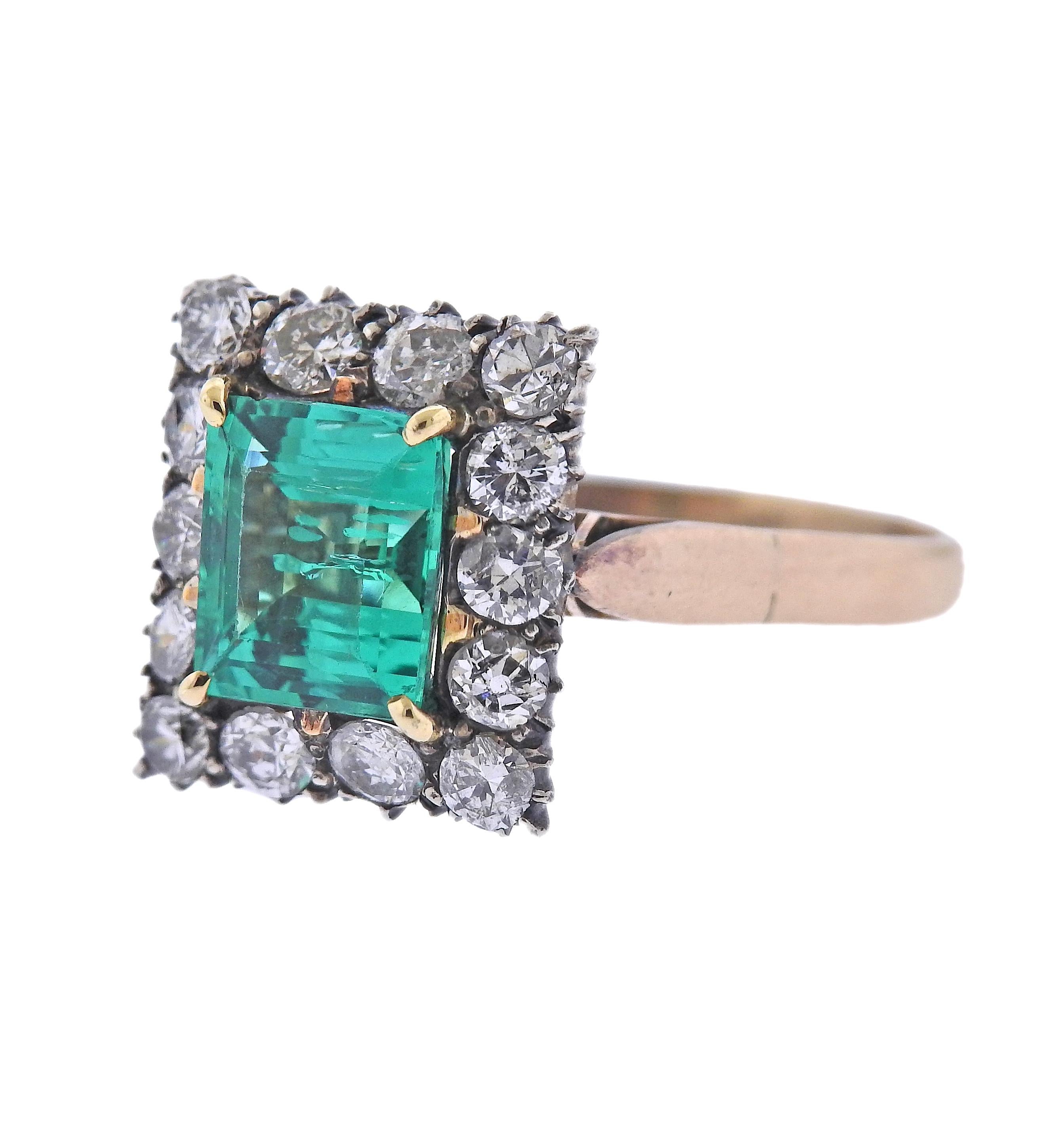 14k gold ring with center approx. 2.18ct emerald (stone measures 8.7 x 7.55 x4.8mm, has internal fracture), surrounded with approx. 1.40ctw in H-I/Si diamonds. Ring size 8.5 (EU 58.5) and top is 15 x 14mm, weight 5.6 grams. 