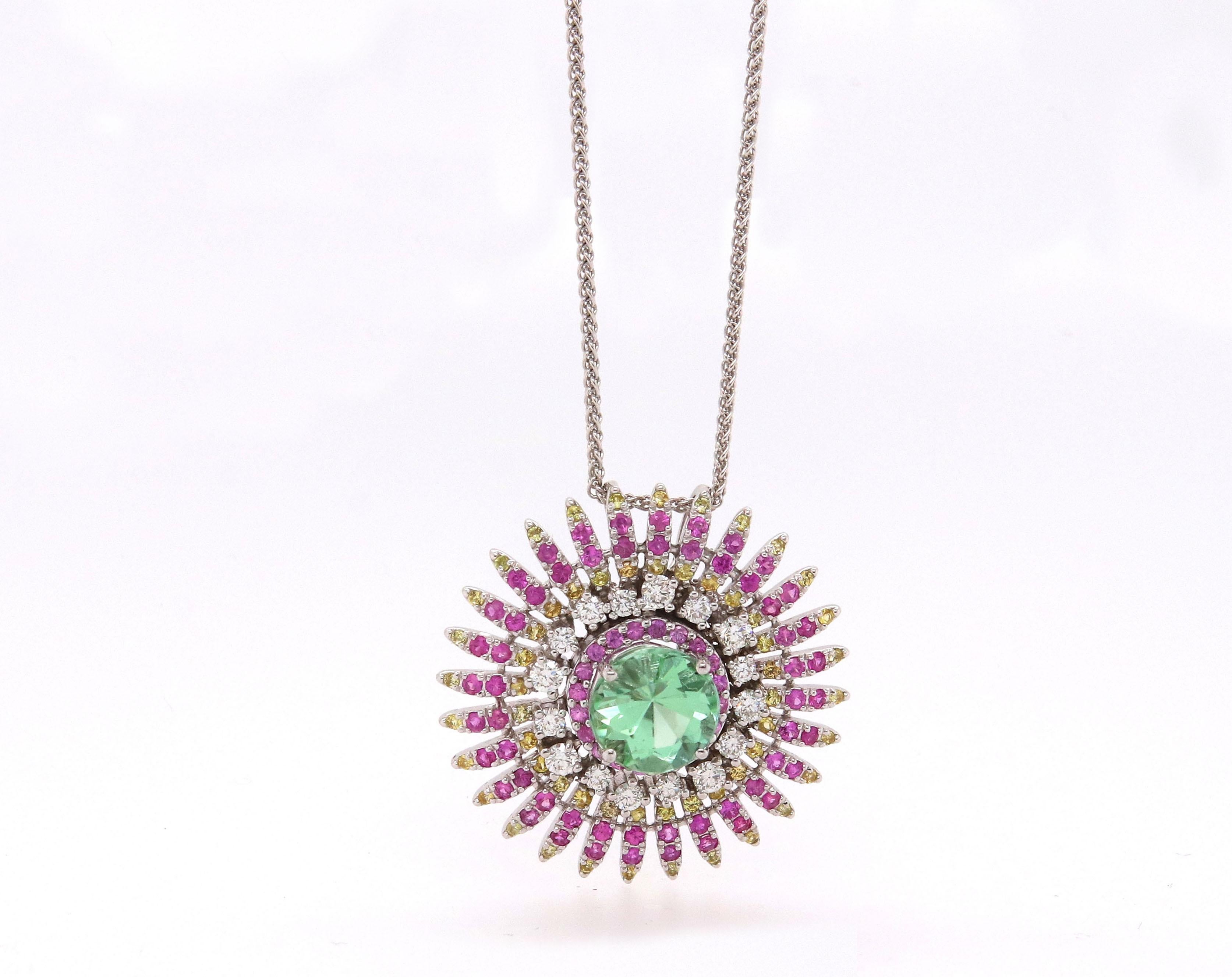 Material: 14k White Gold 
Center Stone Details: 1 Round Green Tourmaline at 2.18 Carats- Measuring 8 mm
Mounting Stone Details: 76 Round Pink Sapphires at 0.86 Carats
Mounting Stone Details: 59 Round Yellow Sapphires at 0.39 Carats
Diamond Details: 