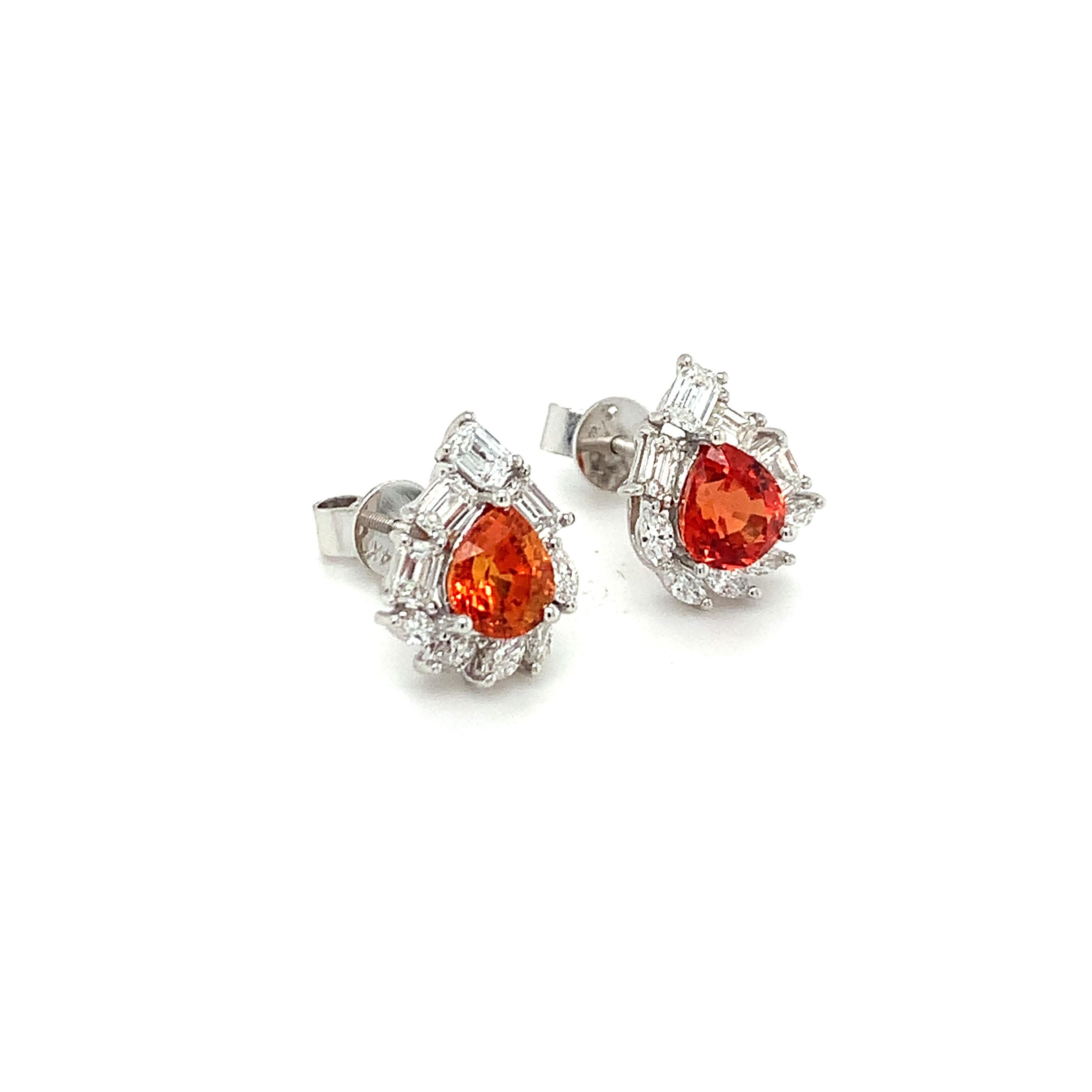 Gorgeous 14K white gold earrings feature a pear shaped natural orange sapphire in each center. Baguette and marquise cut white diamonds surround each center stone making it a stunning piece. The studs secure with screw backs.
Orange Sapphire: 2.18