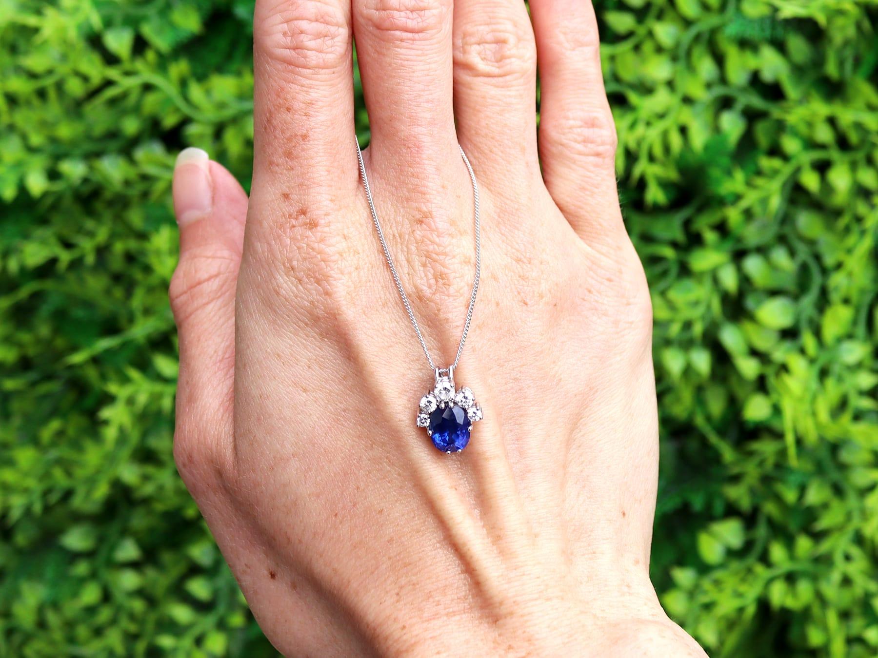 A fine and impressive vintage 2.18 carat blue sapphire and 0.39 carat diamond, 18 karat white gold cluster pendant; part of our diverse vintage sapphire jewelry collection.

This fine and impressive vintage sapphire pendant has been crafted in 18k