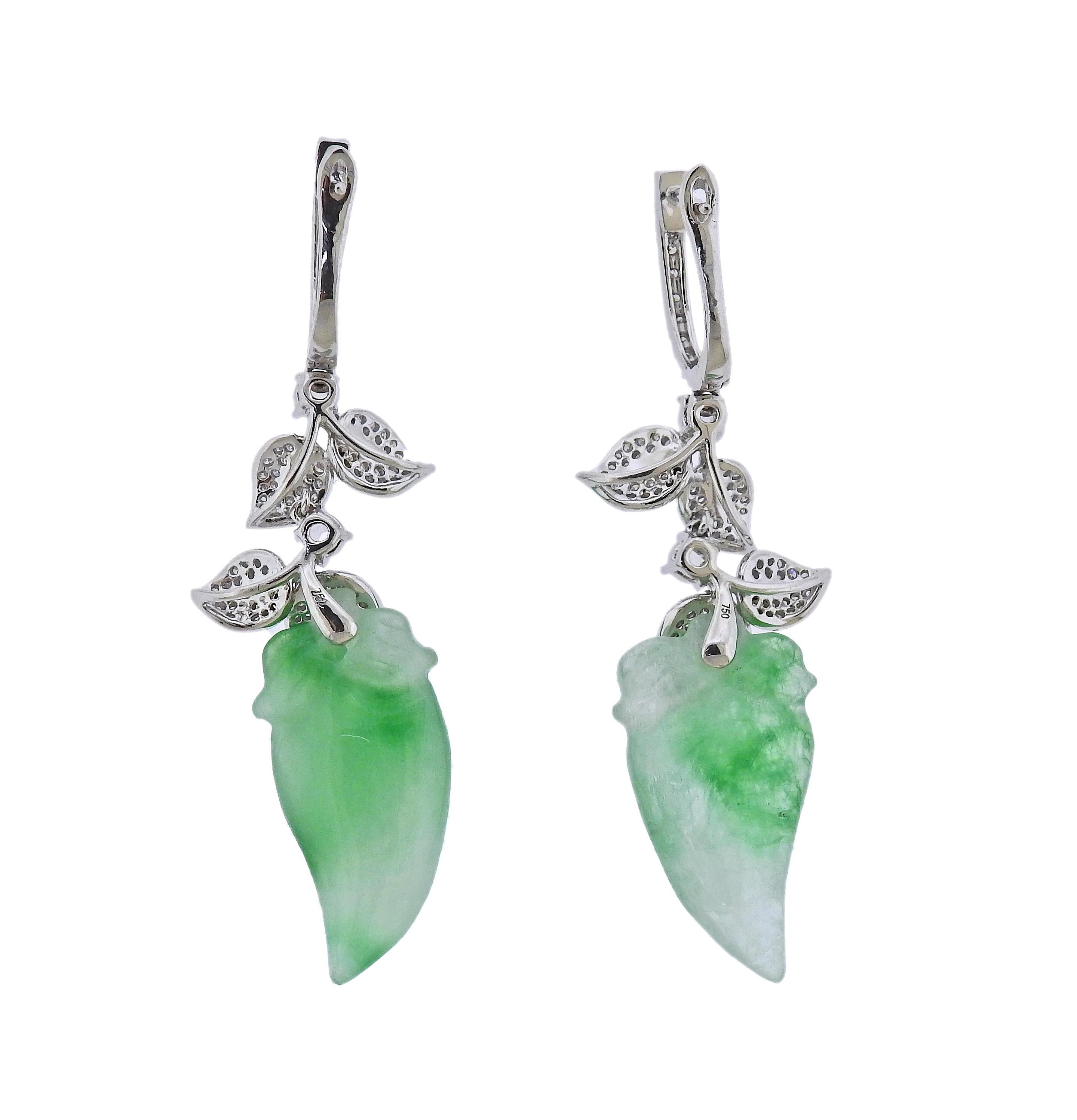 Pair of 18k gold drop earring, with 21.86ctw carved jadeite jade, and 0.81ctw diamonds. Earrings are 51mm long. Marked 750. Weight - 10.6 grams.