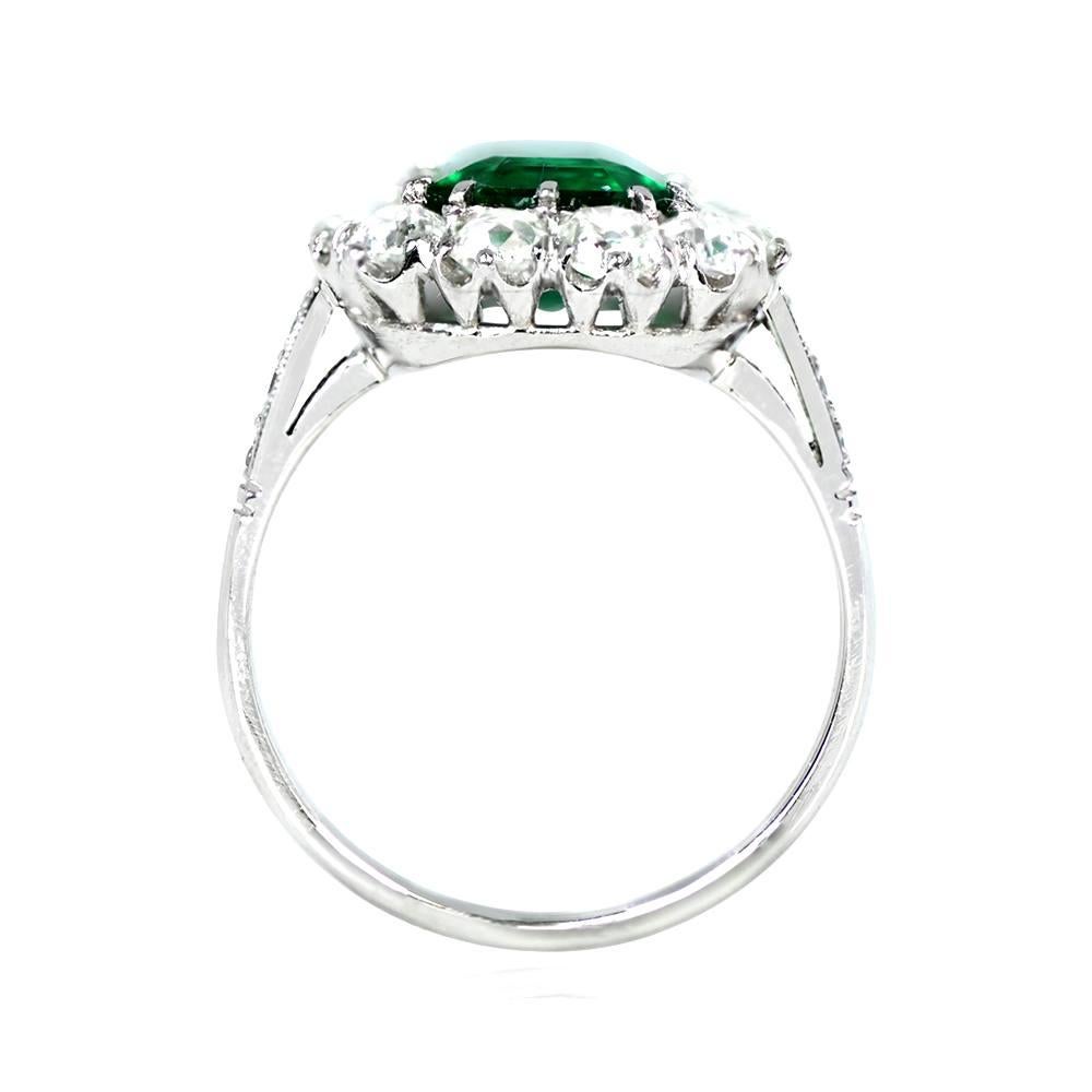 This platinum cluster ring is truly impressive, showcasing a high-quality 2.18-carat natural emerald-cut emerald at its center. The center stone is surrounded by a cluster of old European cut diamonds, accentuating the beauty of the emerald. With a
