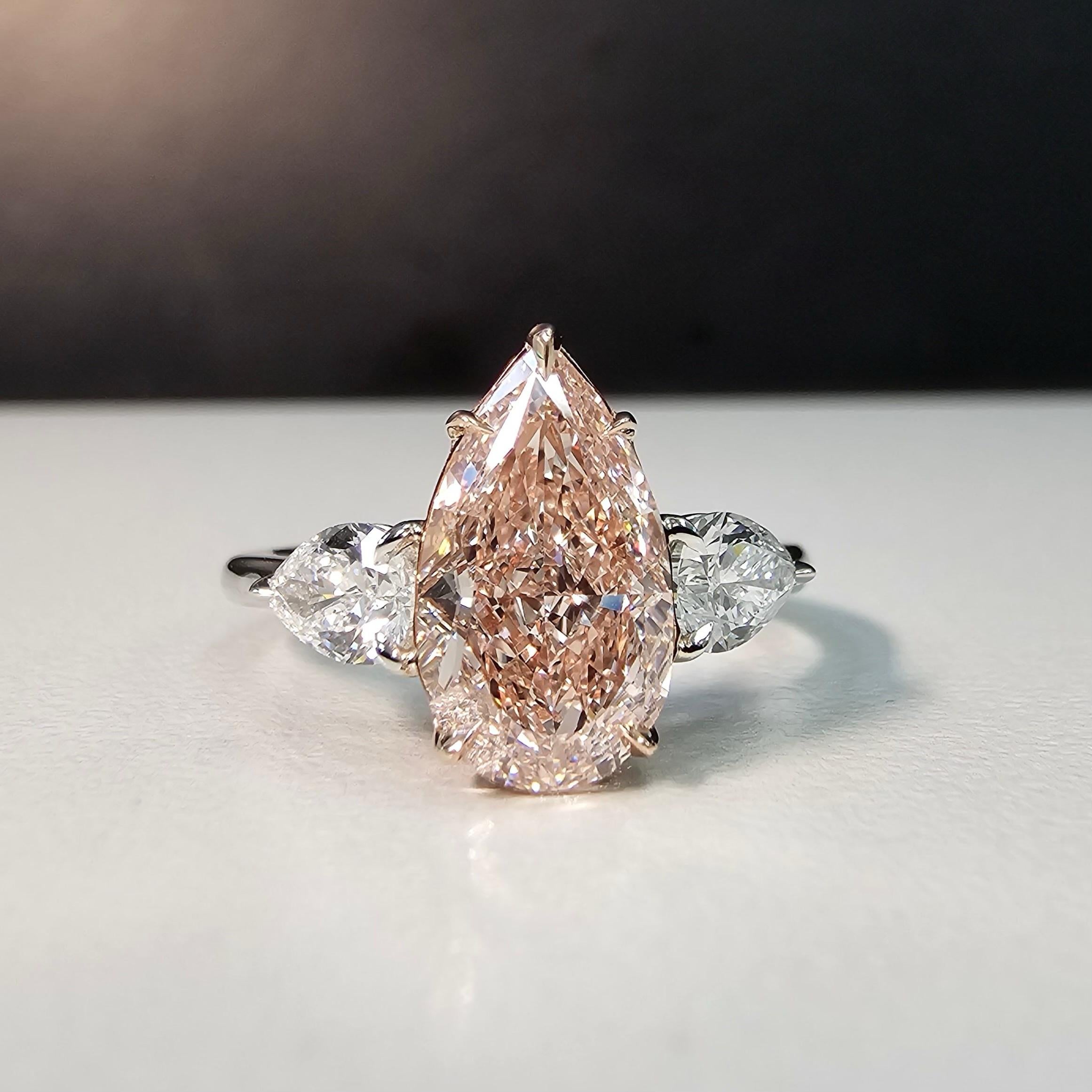 Sensational pear shape cut to perfection. Long model, zero bow tie, and absolutely on fire
Color is as sweet as brown pinks get, definitely see mainly pink
10/10 model 
Set in Platinum and Rose Gold with 0.61ct of G VS Pear shapes
This piece can be