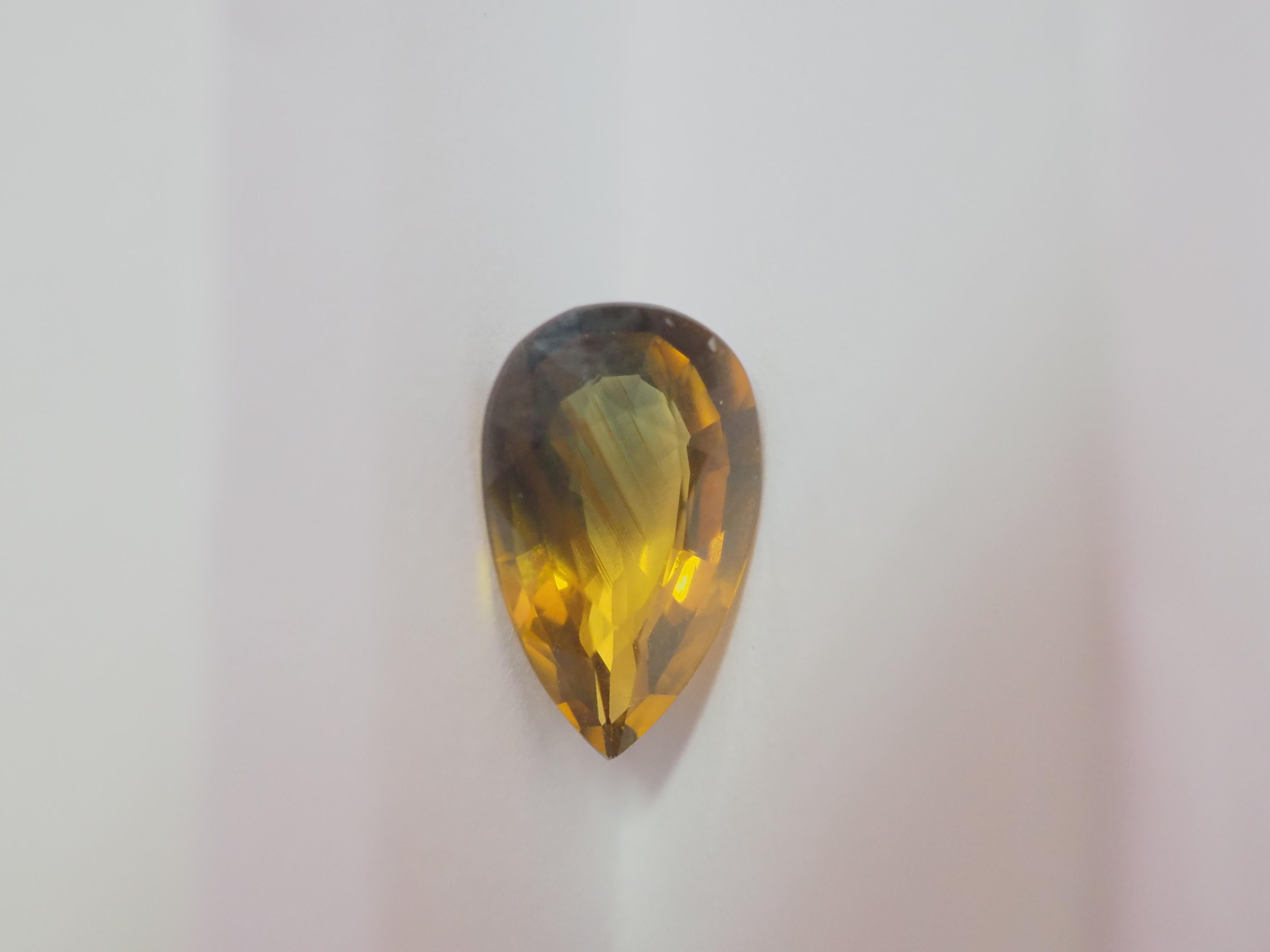 This particular gem measures approximately 11mm in height, 6mm in width, and 3.5mm in depth, providing ample space for intricate and creative jewelry designs. 

Bi-color pear cut greenish yellow sapphire.
Weight= 2.18 carats
treatment: no indication