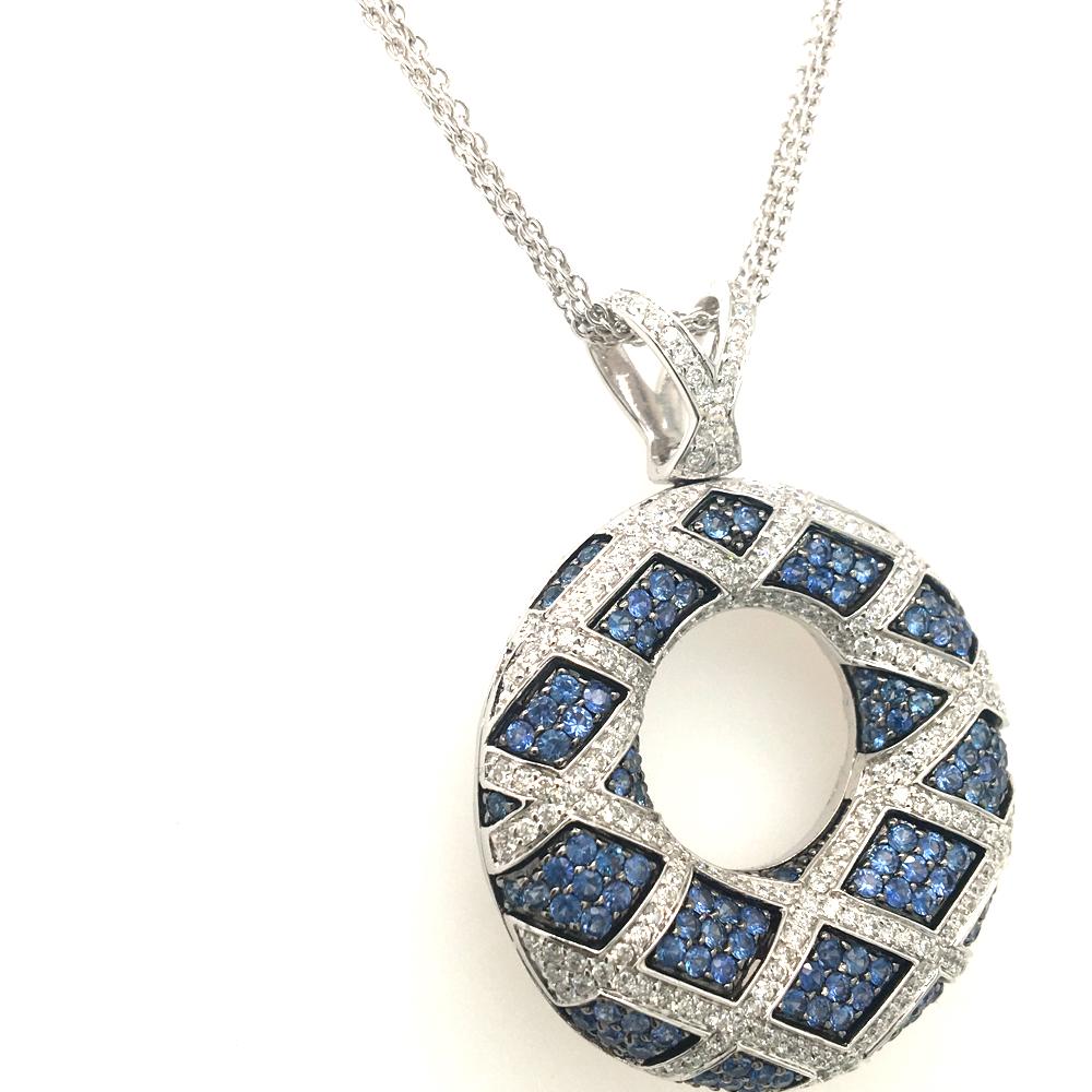 18KT White Gold Circle pendent
set with 2.19 carats of round Blue sapphire 
1.28 of Round cut diamonds G color VS clarity
Blue sapphire stones are set  on Oxidite Gold
the back of the pendent has a nice gallery making it very comfortable on the