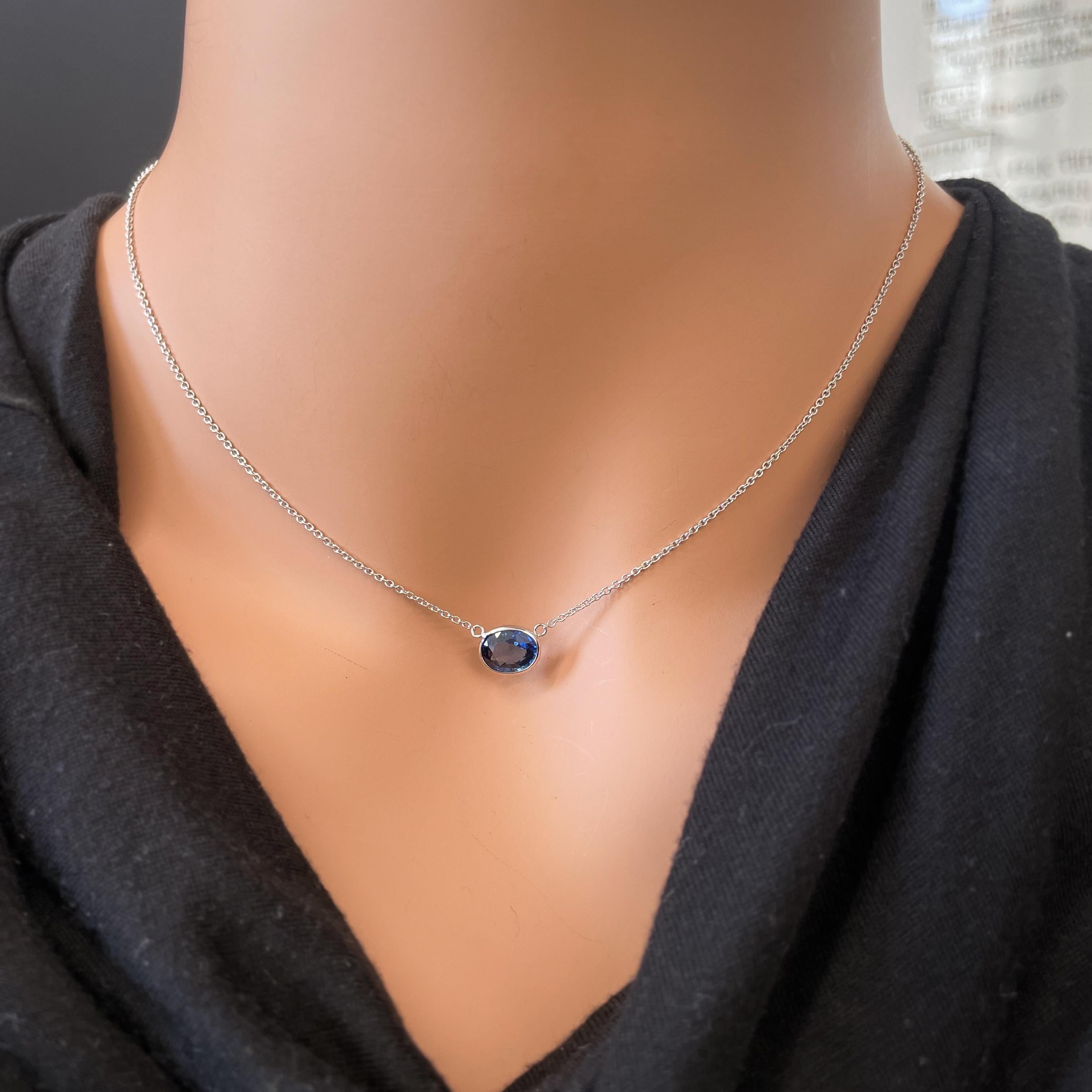 This necklace features an oval-cut blue sapphire with a weight of 2.19 carats, set in 14k white gold (WG). Blue sapphires are highly sought after for their rich, deep blue color, and the oval cut is a classic and timeless choice for gemstones,