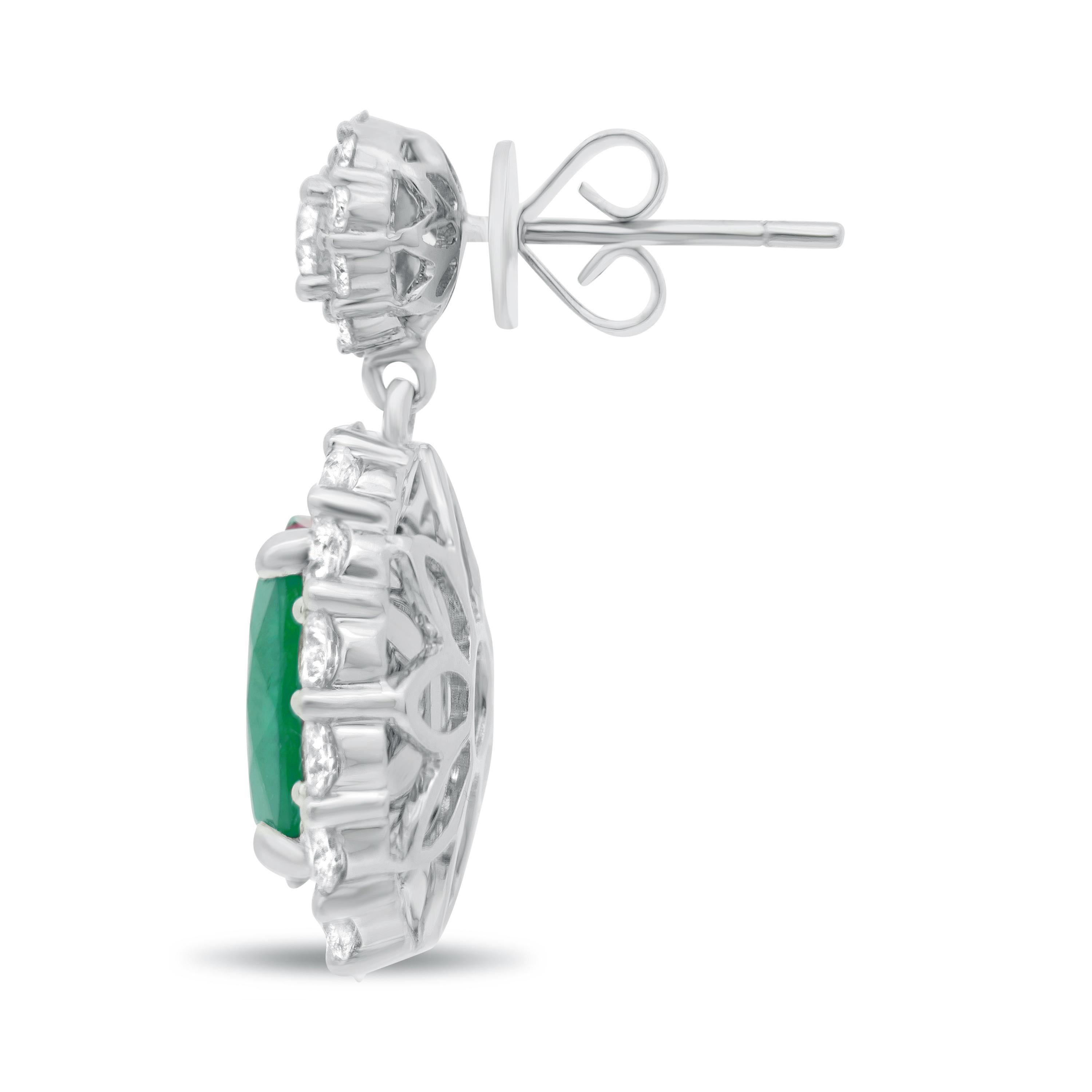 Oval Cut 2.19 Carat Total Weight Emerald and Diamond Earrings Set in 18 Karat White Gold For Sale
