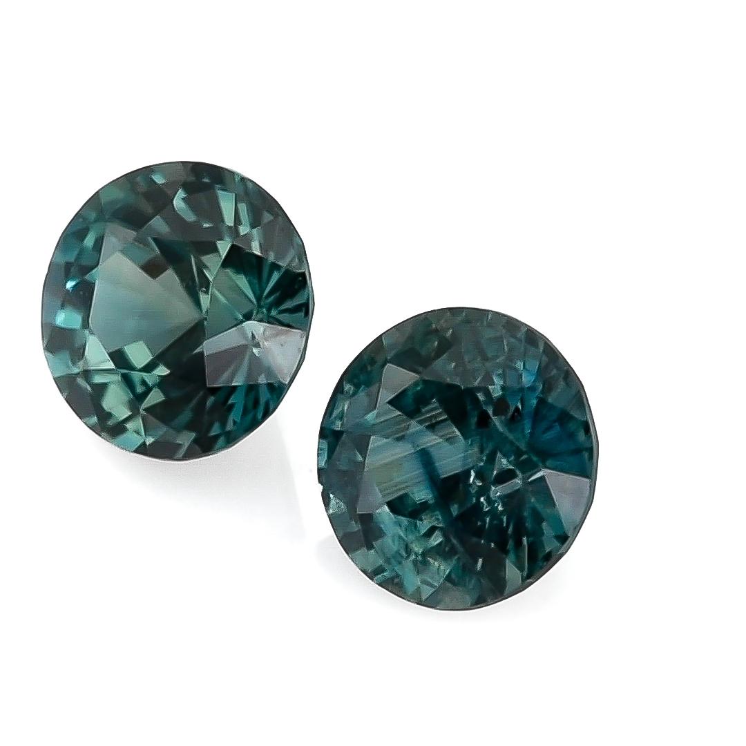 Introducing a striking Natural Blue-Green Sapphire weighing 2.19 carats. This round-shaped gem measures 5.97 x 5.93 x 4.15 mm and 6.02 x 6.01 x 4.29 mm respectively, showcasing a captivating blue-green color. The sapphire features a brilliant/step