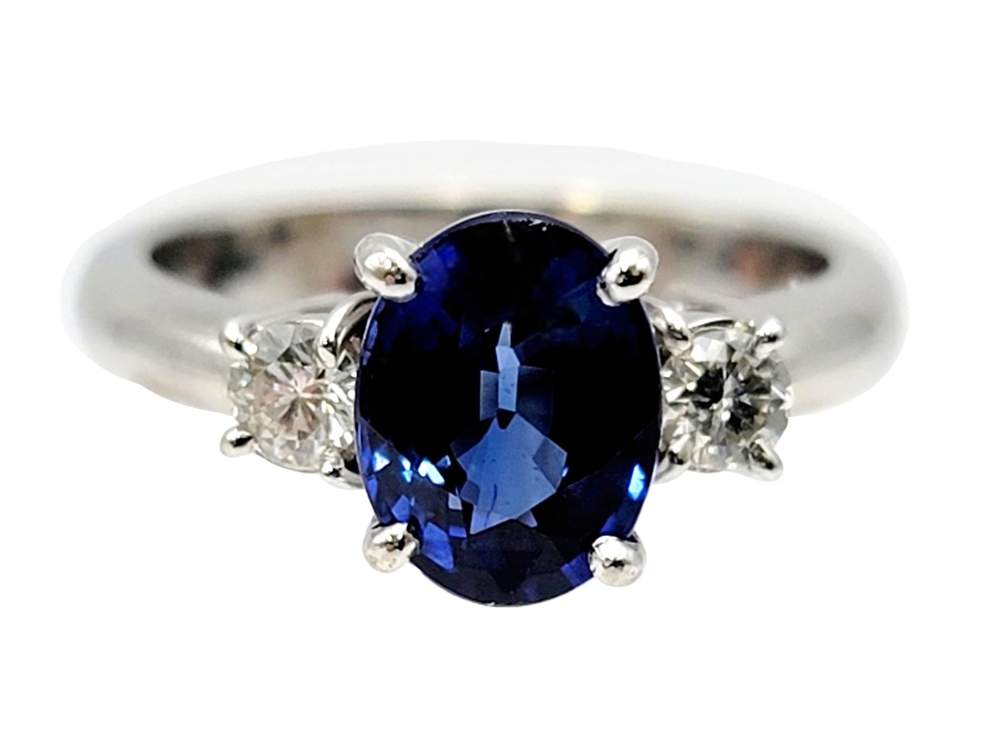 Ring size: 5.25

Gorgeous three stone sapphire and diamond ring. An incredible oval mixed cut natural sapphire stone is prong set at the center of the piece and flanked by 2 round diamonds. The icy white diamonds set against the bright blue stone