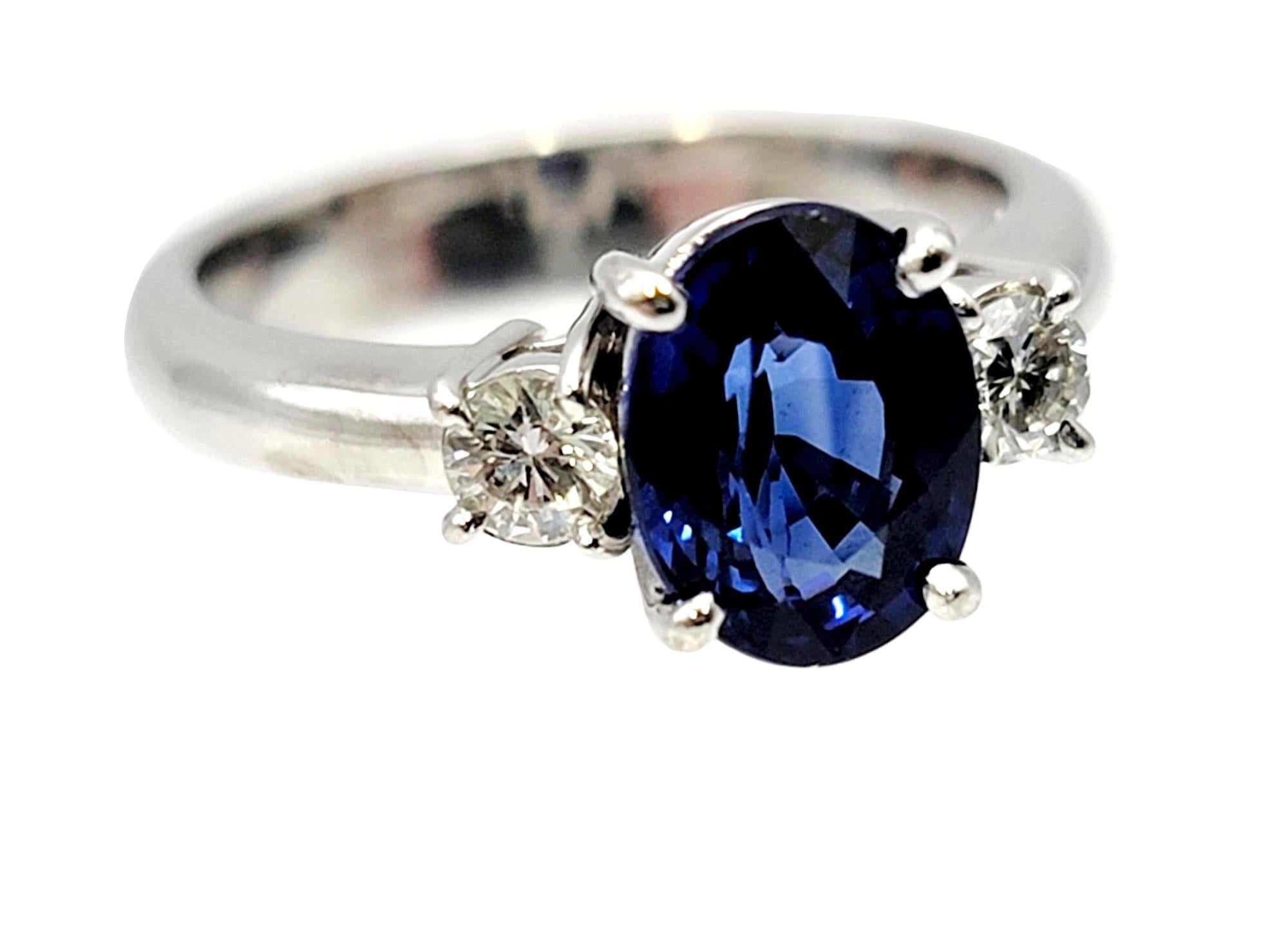 Contemporary 2.19 Carats Total Oval Natural Blue Sapphire and Round Diamond Three Stone Ring For Sale