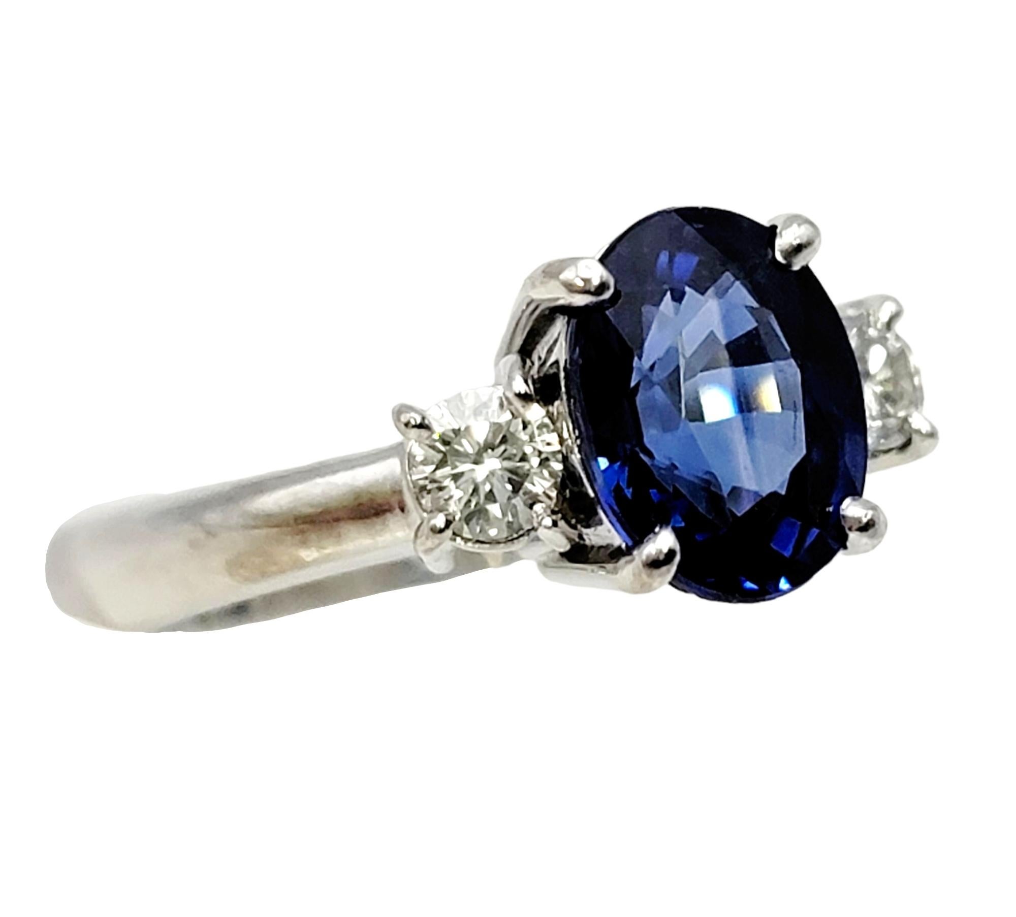 Oval Cut 2.19 Carats Total Oval Natural Blue Sapphire and Round Diamond Three Stone Ring For Sale
