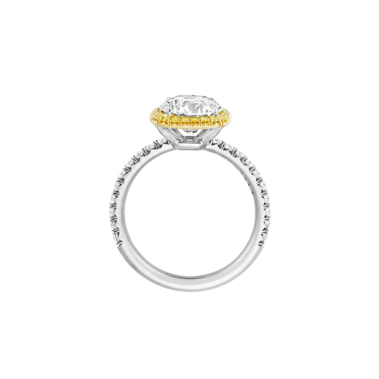 This beautiful 2.19 ct round GIA Certified stone is set in Platinum and 18kt and surrounded by .16 ct. total weight of Fancy Intent Yellow diamond melee along with .37 ct. total weight of FVS white diamond melee. It is currently a size 6.25 but can