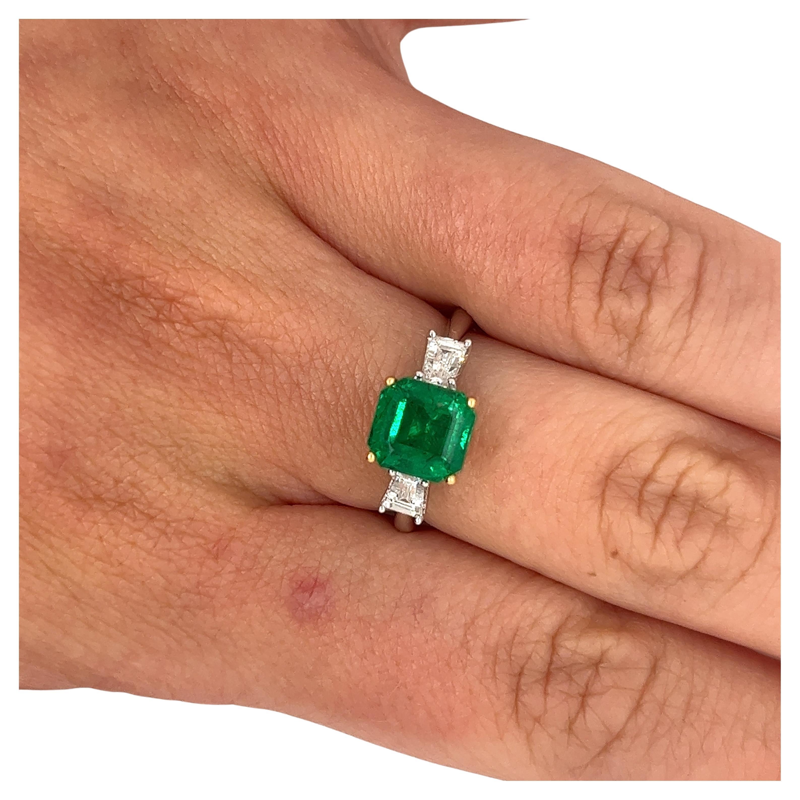 2.19 carat natural Zambian emerald and diamond ring in two-tone 18k white and yellow gold.

The emerald bears excellent luster, and a rich dark green saturation with lighter shades radiating inside the stone as light reflects it at different angles.