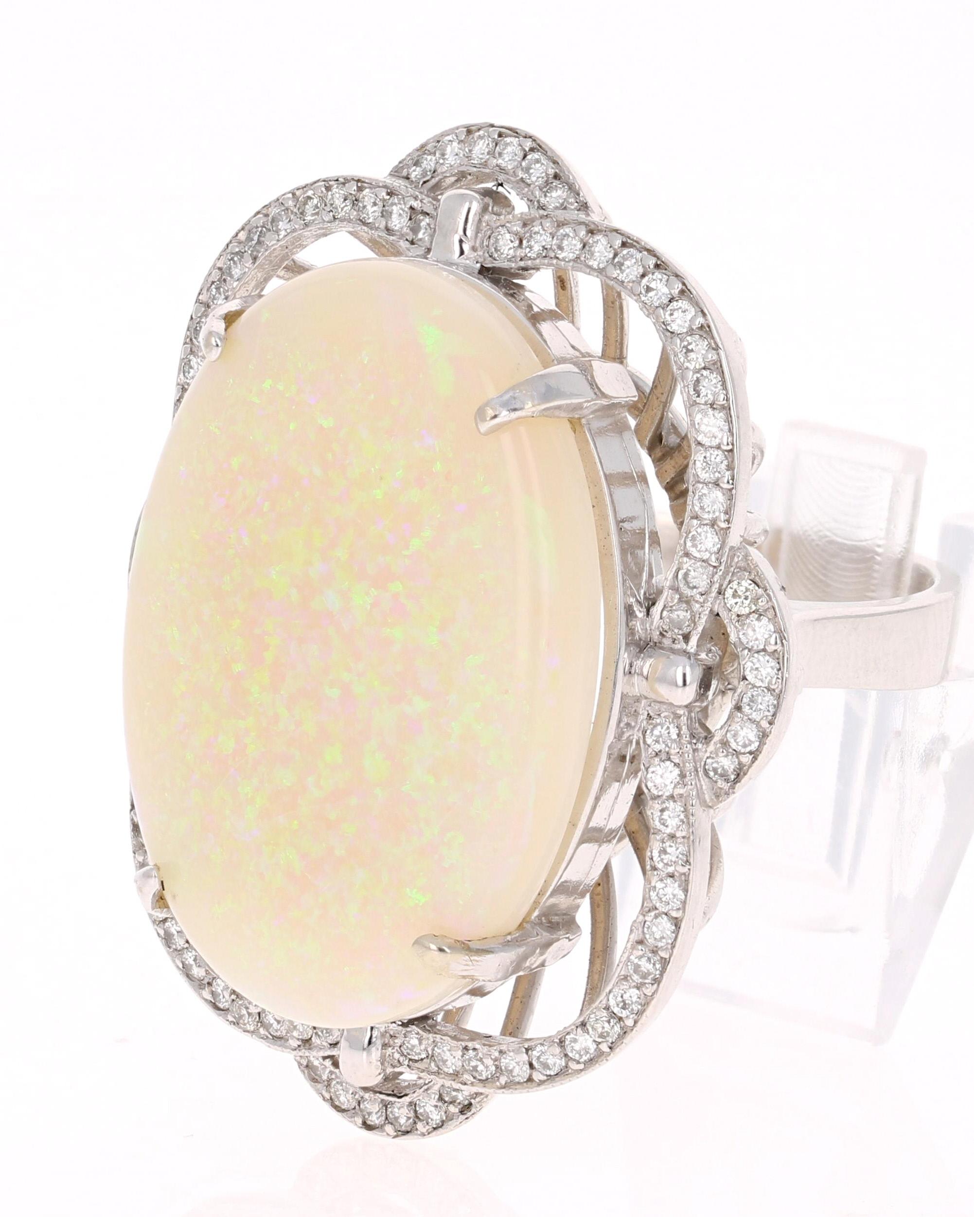 One Of A Kind Opulent Opal Diamond Ring with a setting that is Inspired by the Victorian Era! 

This ring has a 21.14 Carat Opal that is curated in a unique 14 Karat White Gold setting. The setting is adorned with 84 Round Cut Diamonds that weigh