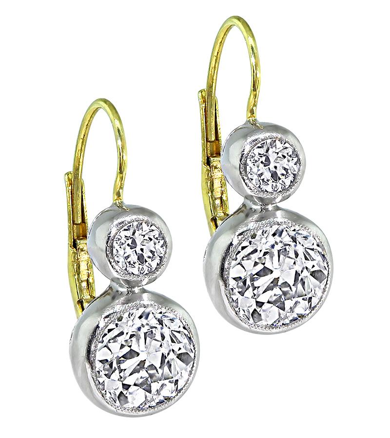 This is an amazing pair of platinum and 18k yellow gold earrings. The earrings feature sparkling old mine cut diamonds that weigh approximately 2.19ct. The color of these diamonds is H with VS2-SI2 clarity. The earrings measure 18.5mm by 8mm and
