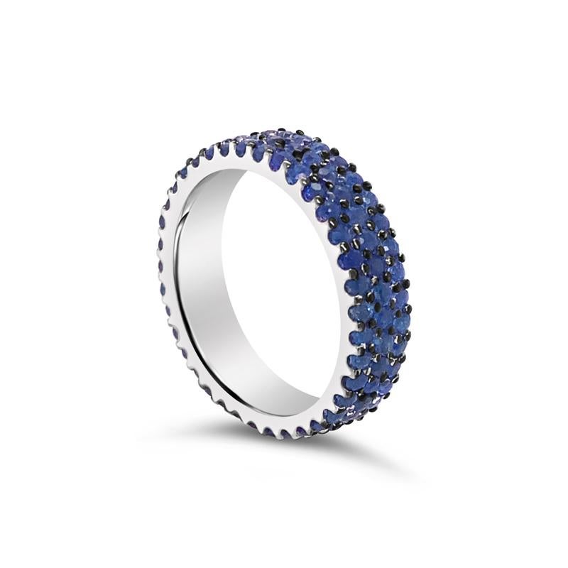 This beautiful eternity band features 2.19 carat total weight in 3 rows of round natural blue sapphires set in 14 karat white gold. This ring is a size 6. It can be worn alone or stack with other bands. 
Measurements: 5mm wide