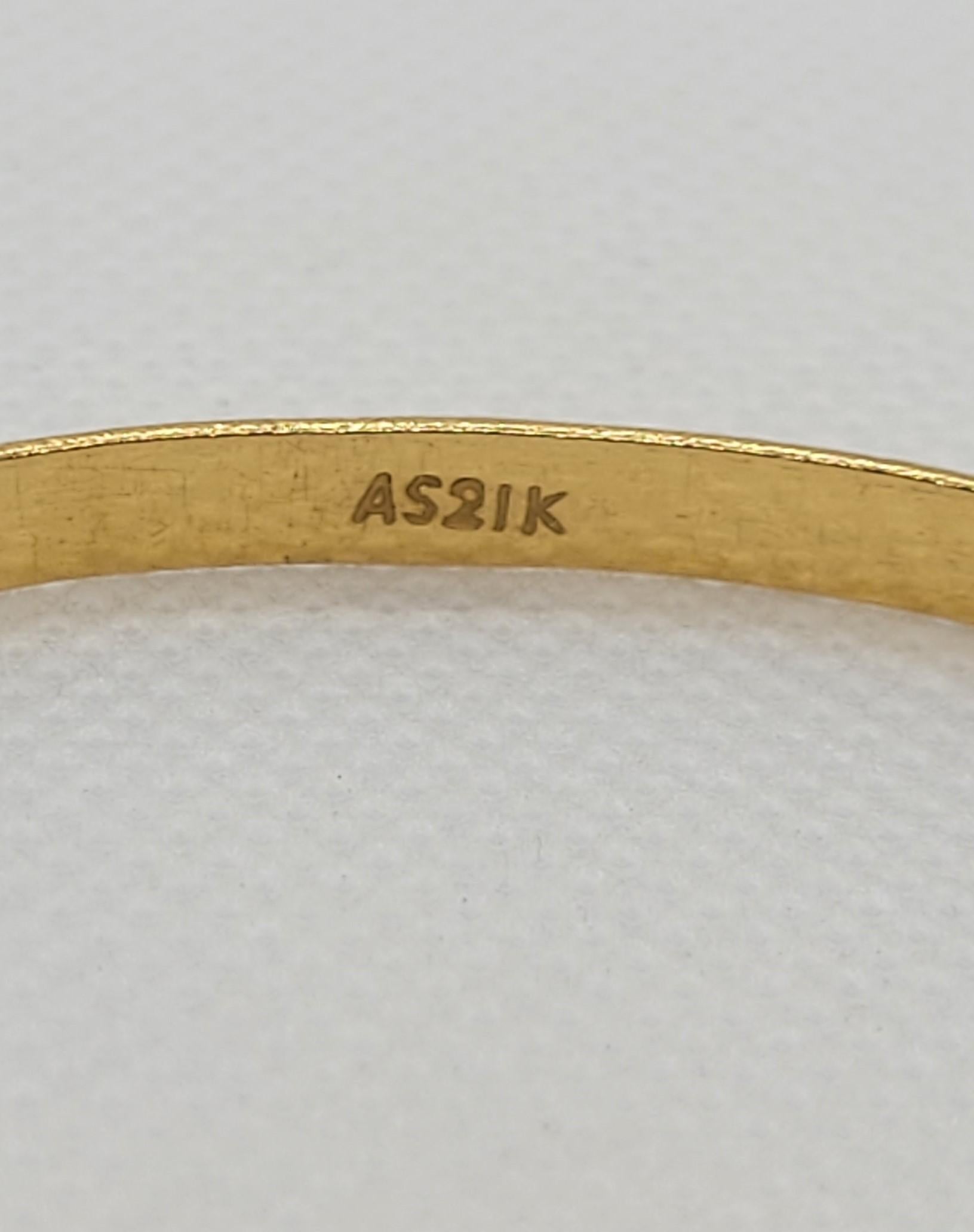 Beautiful 21kt gold bangle bracelet that weighs 10.92 grams. The bracelet has a lovely diamond-cut design, is 4.3 mm wide, 1 mm thick and the diameter is approximately 67mm. The inside of the bangle is stamped AS21K. Overall, the bracelet is in very