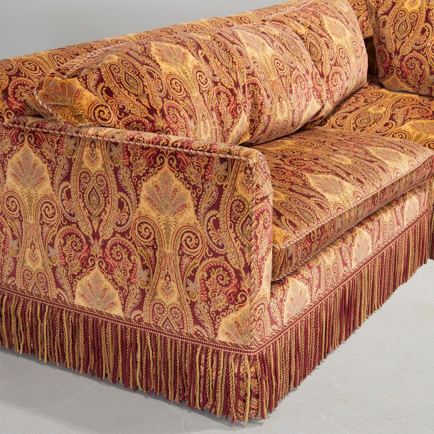 Circa. 2006, a show stopping, one-off velvet sectional sofa with queen sleeper. The gorgeous jewel toned velvet paisley fabric is purportedly by Ralph Lauren. The base of each section is trimmed with a luxe bullion fringe, Custom designed by award
