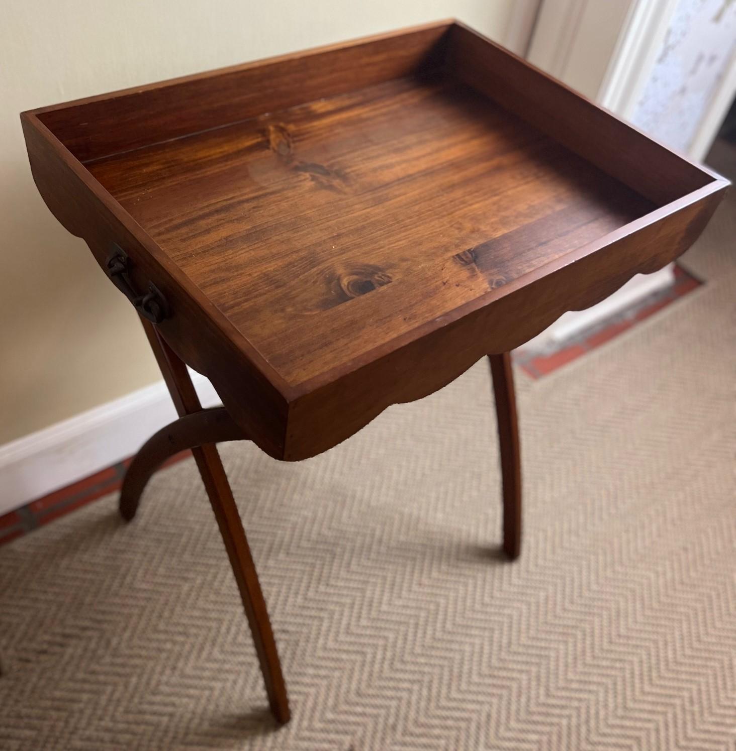 21st C. highly functional folding tray/butlers table with iron handles. The rectangular tray with scalloped edges to all sides, sits on a folding base with curved teak legs.

A pretty and useful table that could be used as a bar, side table,