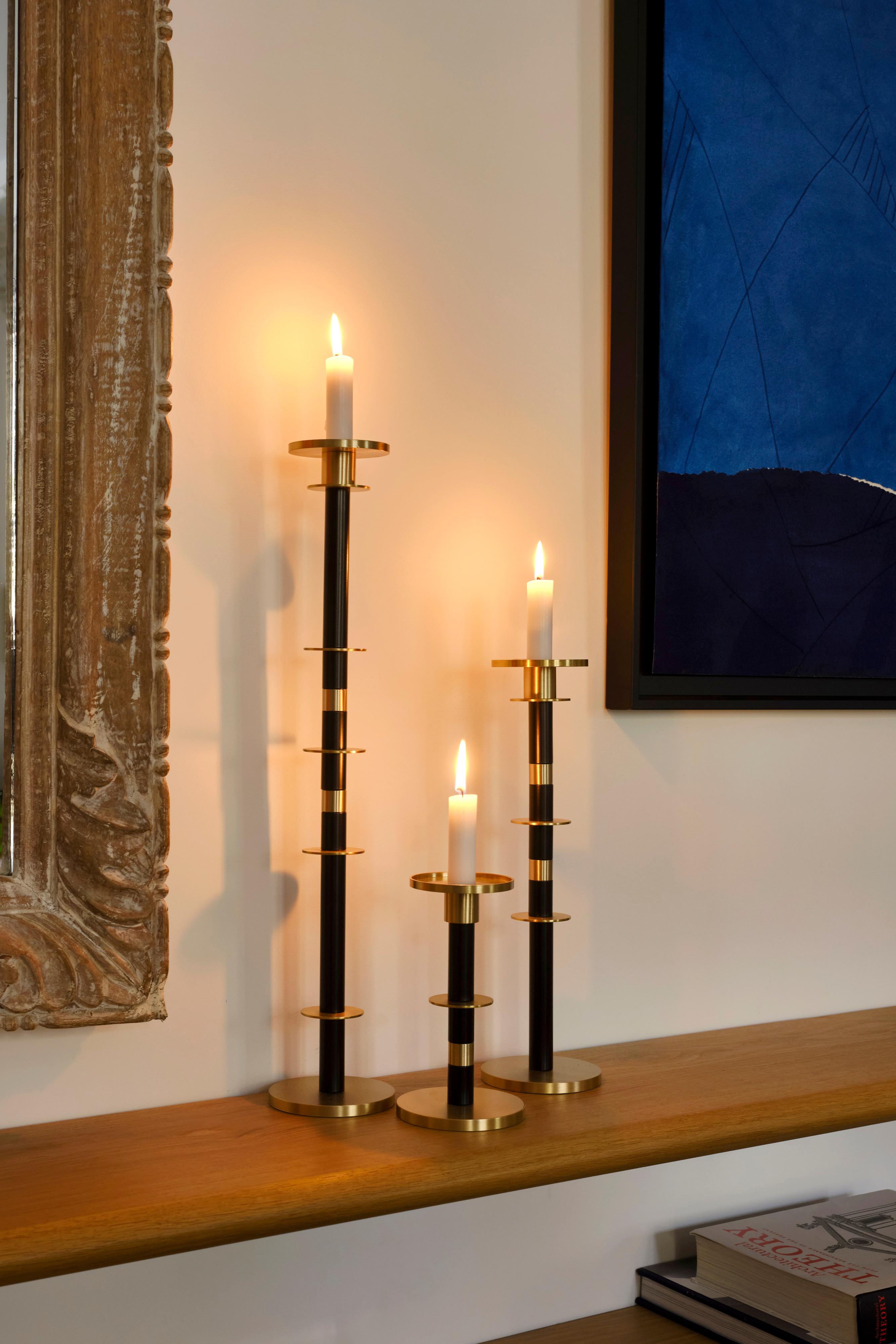 The contrast between the raw metals and the fluidity of the wax defines the iconic design of Marine Breynaert's candlesticks. Each piece is a minimal architectural composition, blending shapes, sizes, and colors in a captivating manner. Whether