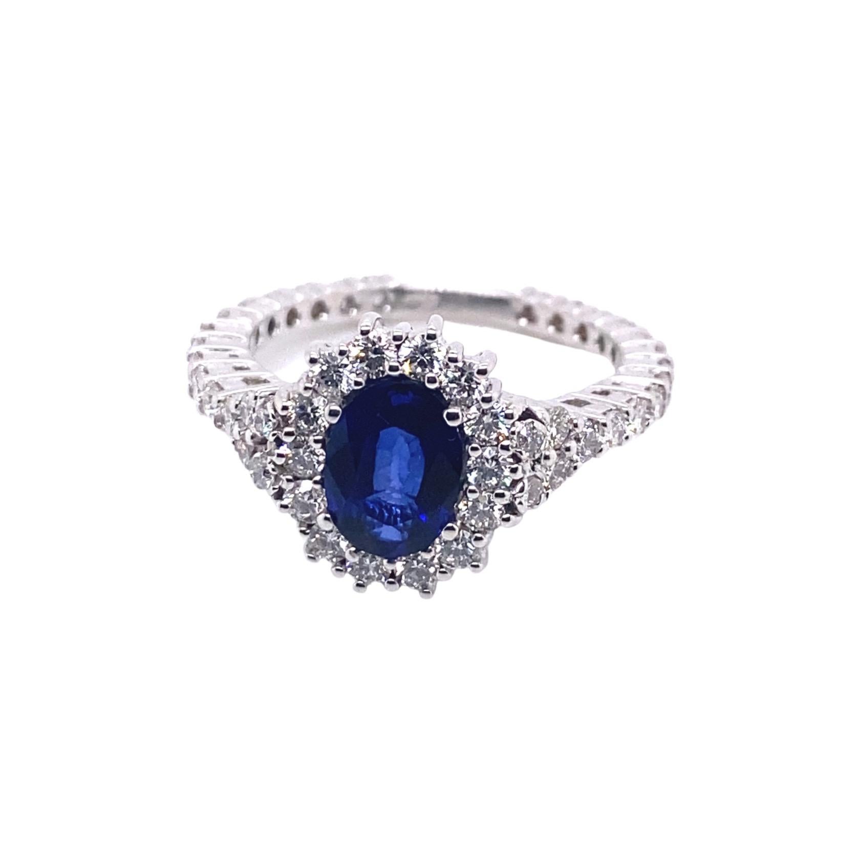Introducing a breathtaking cocktail ring that epitomizes opulence and sophistication. Handcrafted with exceptional artistry in Palermo, Sicily, by master jewellers, this 18-karat white gold ring showcases a central 1.48-carat blue sapphire with a
