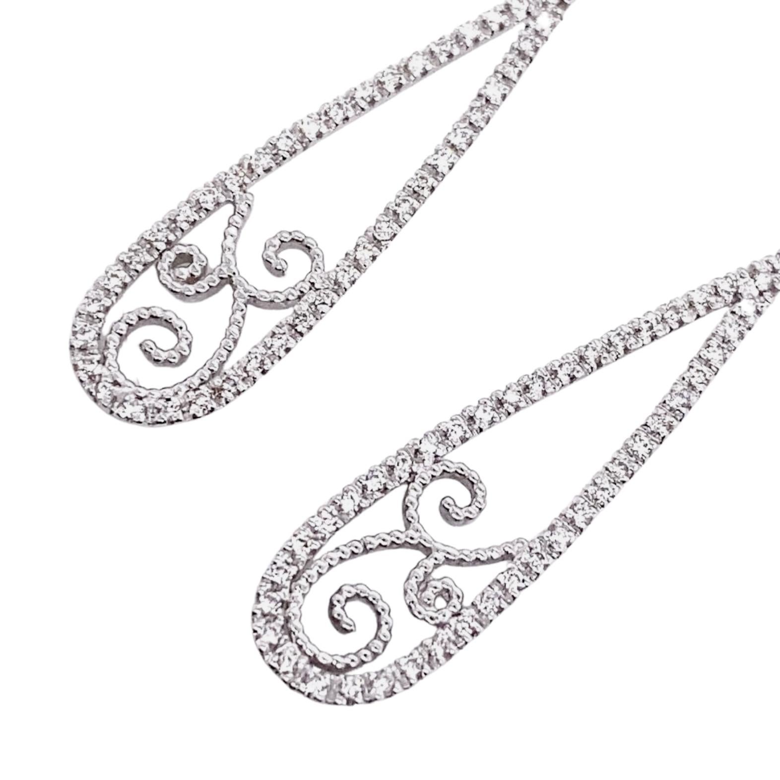 A charming pair of 18-karat white gold and F/G-VVS diamond earrings masterfully created by hand. 

The earrings fasten with an elegant French clip and post. They weigh about 4.7 grams and measure approximately 5 centimetres long. 

Are you looking
