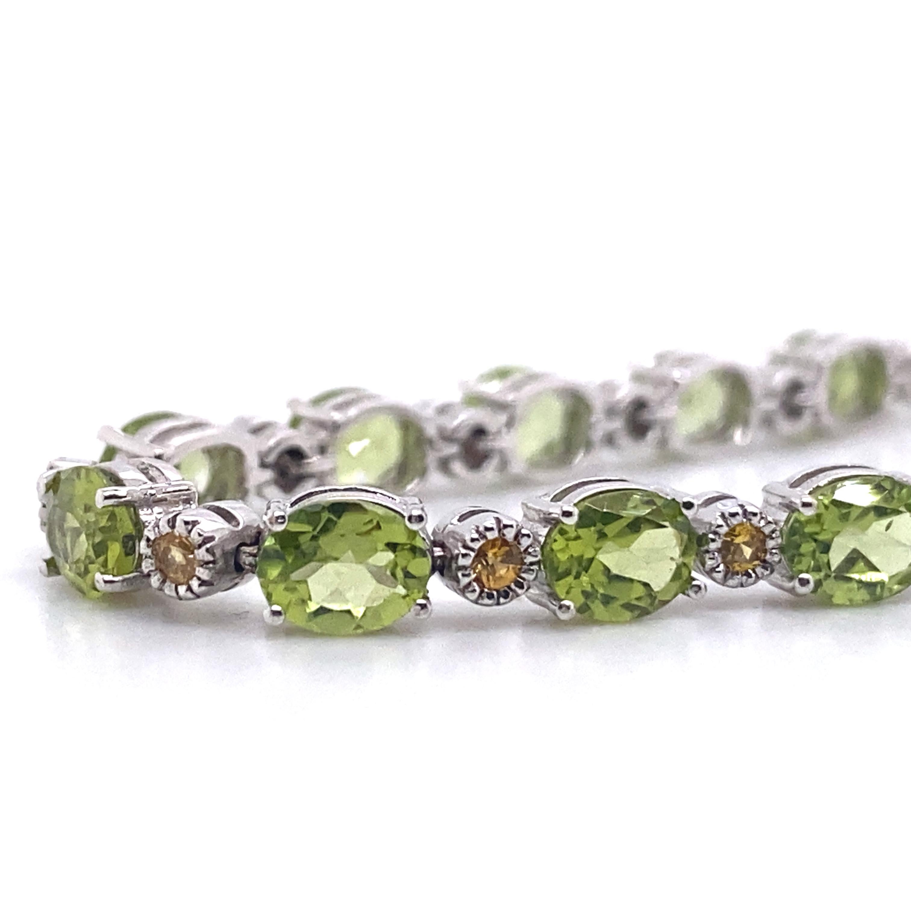 This gorgeous tennis bracelet features 7 carats of peridot and .30 carats of cognac diamonds set in stunning 18-karat white gold. The bracelet is 18 cm long. It was hand-made using traditional methods and designed and produced in Palermo, Sicily by