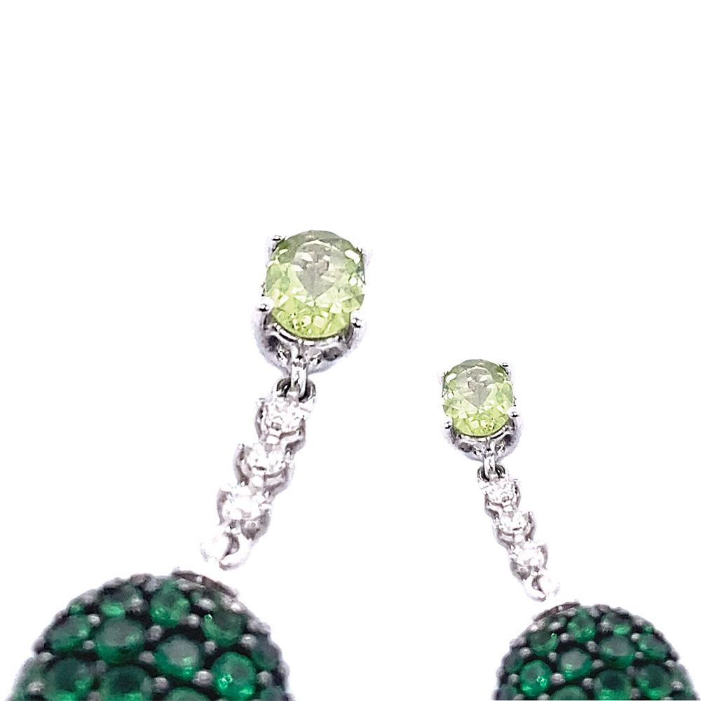 Stunning drop earrings in 18-karat white gold set with 1.70 carats of emeralds, peridot, and V/G-VVS white diamonds, masterfully created by hand. 

The earrings have post backs with butterfly backs. They weigh about 4.8 grams and measure