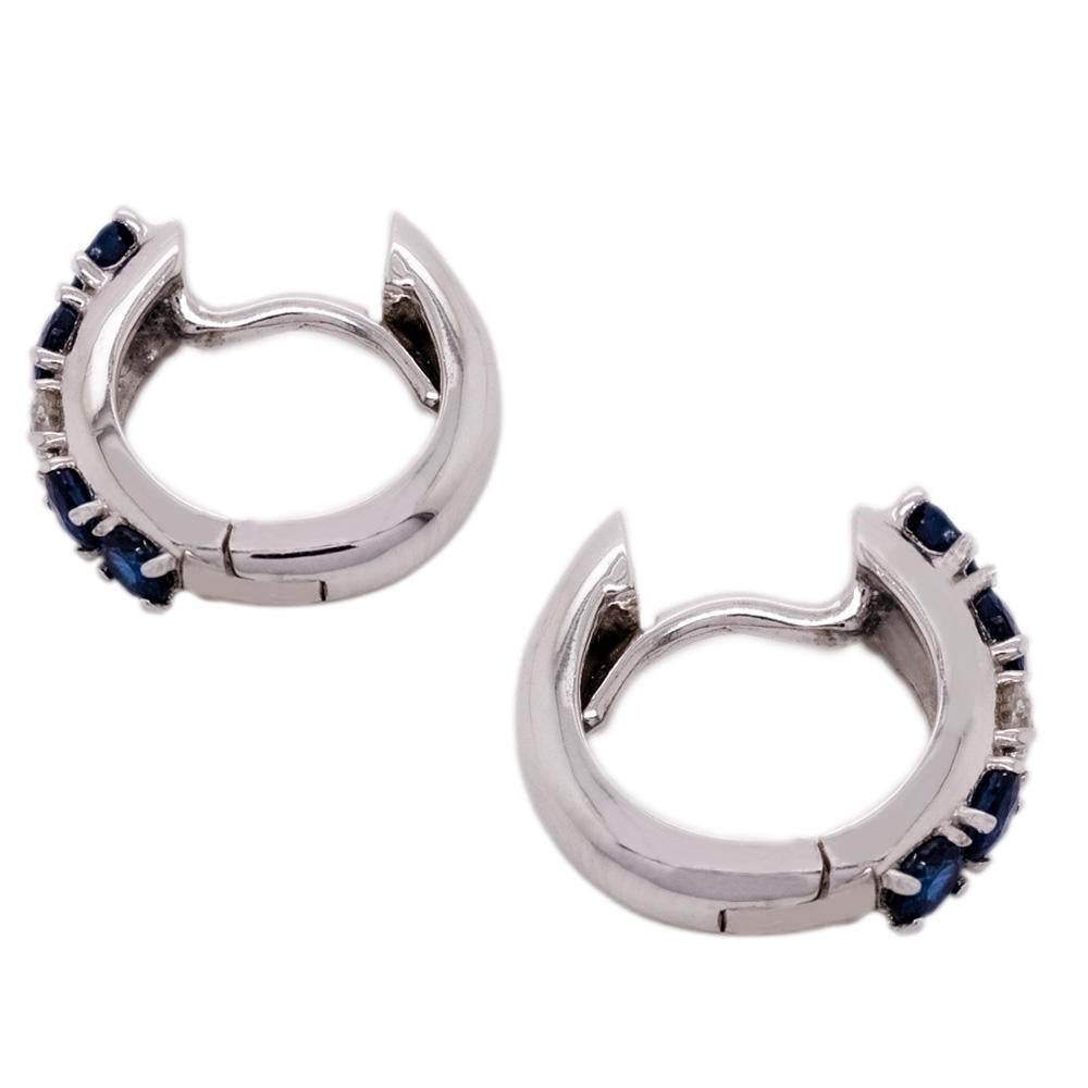 Ein Paar Ohrringe mit Saphiren und Diamanten, meisterhaft von Hand gefertigt. Jeder Ohrring besteht aus einem einzelnen Diamanten, bewertet mit F/G-VVS, der zwischen vier Saphiren liegt. Die Smaragde haben ein Gesamtgewicht von 0,60 Karat und die