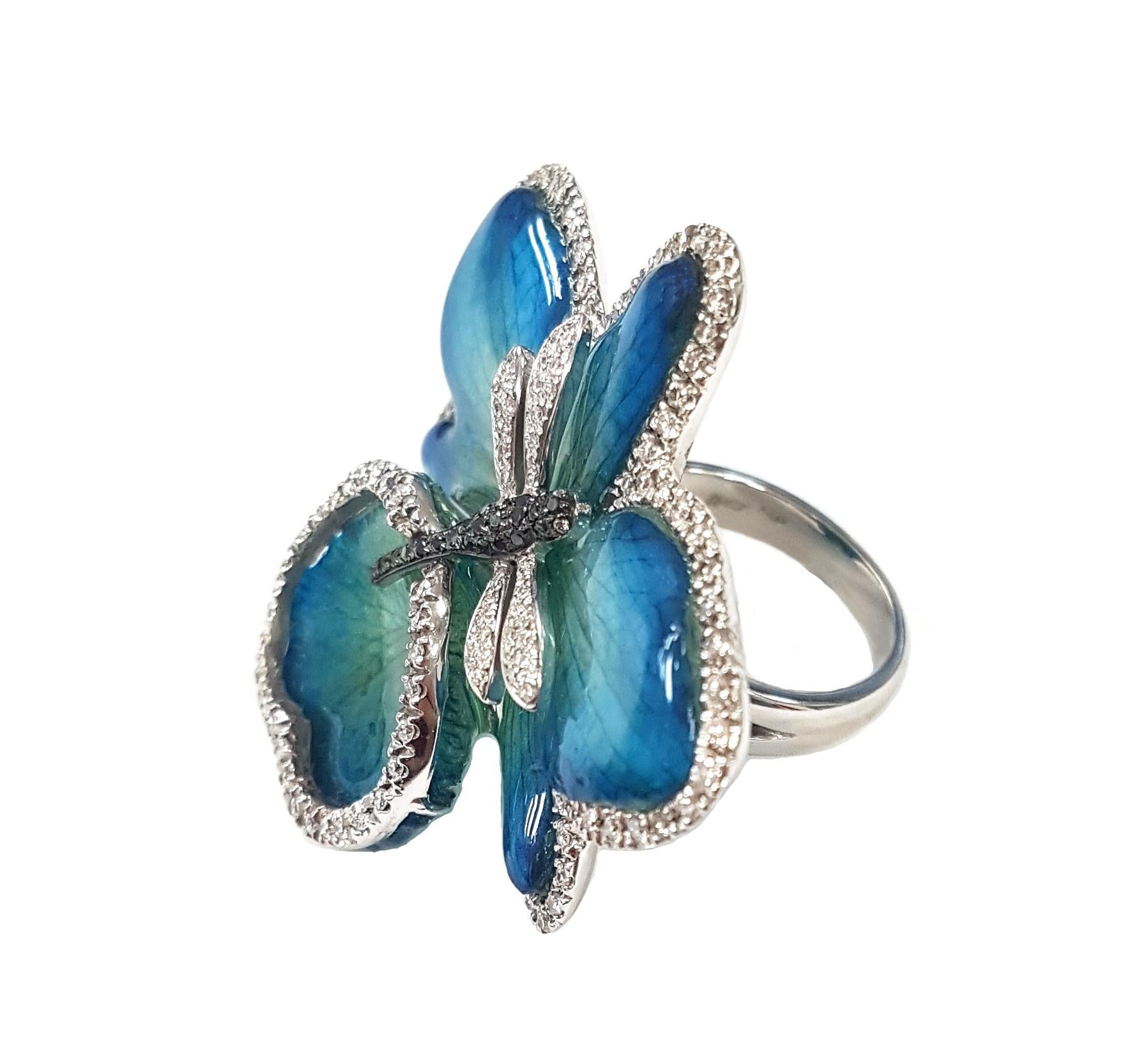 A stunning dragonfly and orchid-flower cocktail ring masterfully created entirely by hand from 18-karat white gold and featuring the entire bloom of a real orchid. Each petal of the orchid is framed by a row of brilliant white diamonds. The