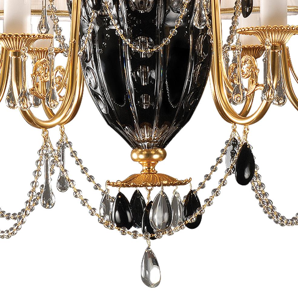 6-Lights chandelier in balck and clear  crystal and gold patinated bronze. 
The parts in crystal are hand-carved. Each object is handcrafted and the care for every detail makes each item unique in its kind. The style of this chandelier is a modern