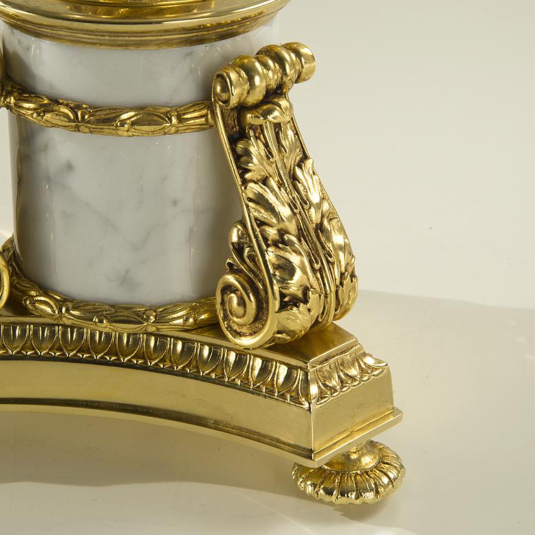 21st century 7- flame gold bronze and veined white Carrara marble candelabra. The bronze parts are made with the lost wax casting technique and then finely chiselled. This Candelabra has got 7-flames. On request to customer can modificate  the metal